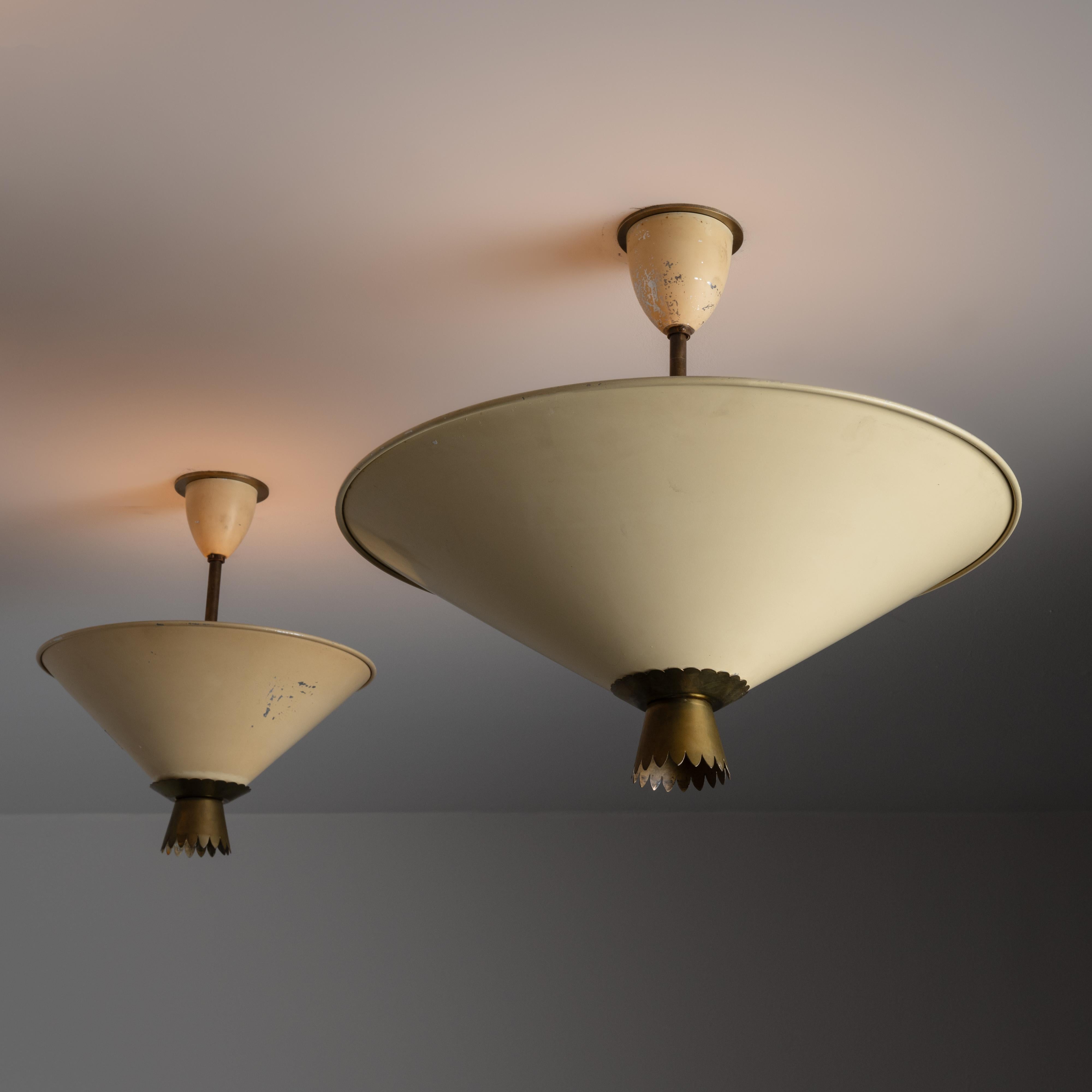 Flush Mounts by Stilux. Designed and manufactured in Italy, circa the 1950s. Cream colored shades with aged brass bottom scalloped accent. Each fixture holds a tri-socket, adapted for the US. We recommend 40w max bulbs. Bulbs not provided. Please