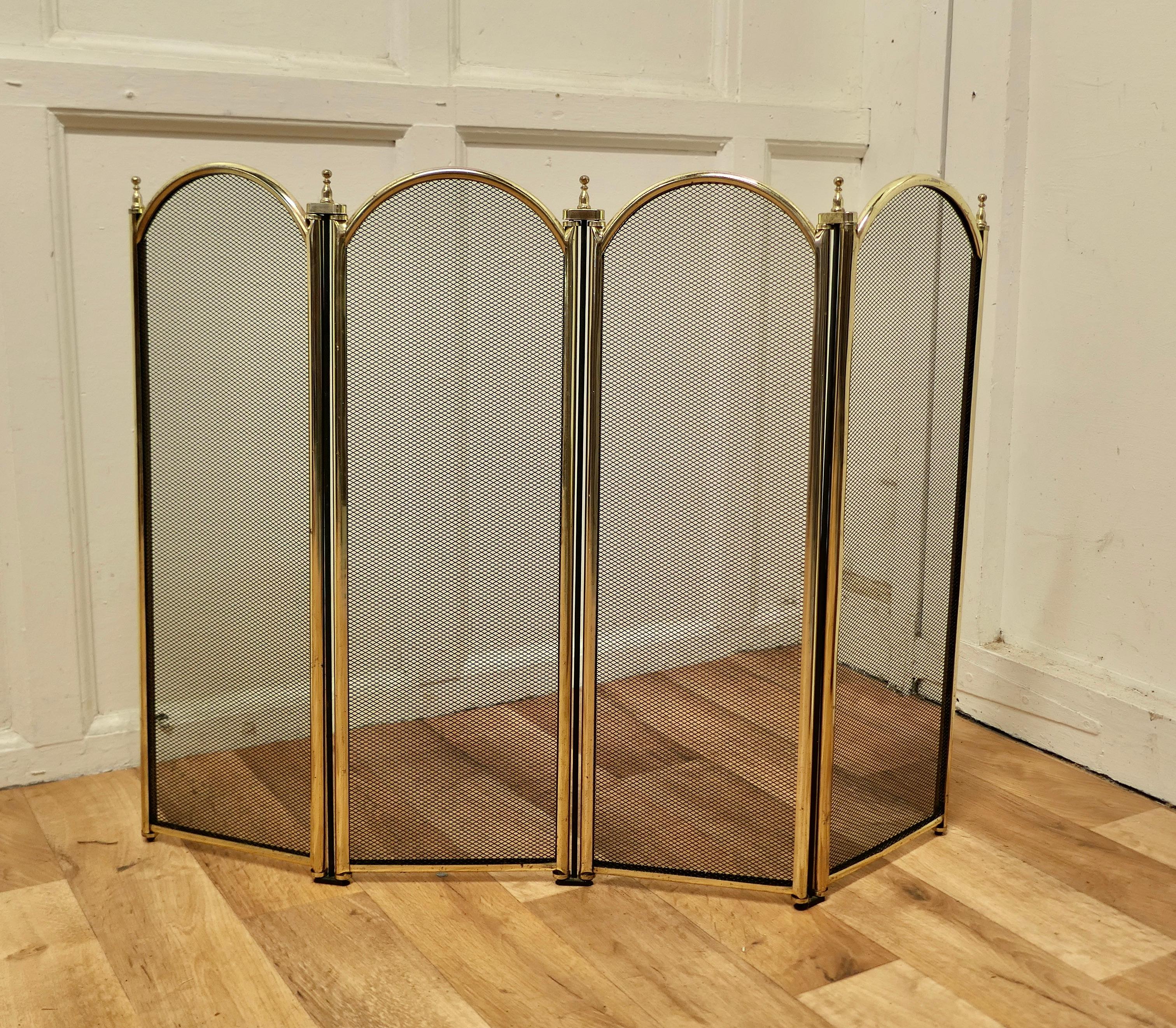 Large folding brass and iron fire guard for Inglenook Fireplace.

This very useful spark guard has a 4 fold brass frame and a fine black mesh infill decorated with brass finials along the top. 
When opened out the screen can be shaped to enclose