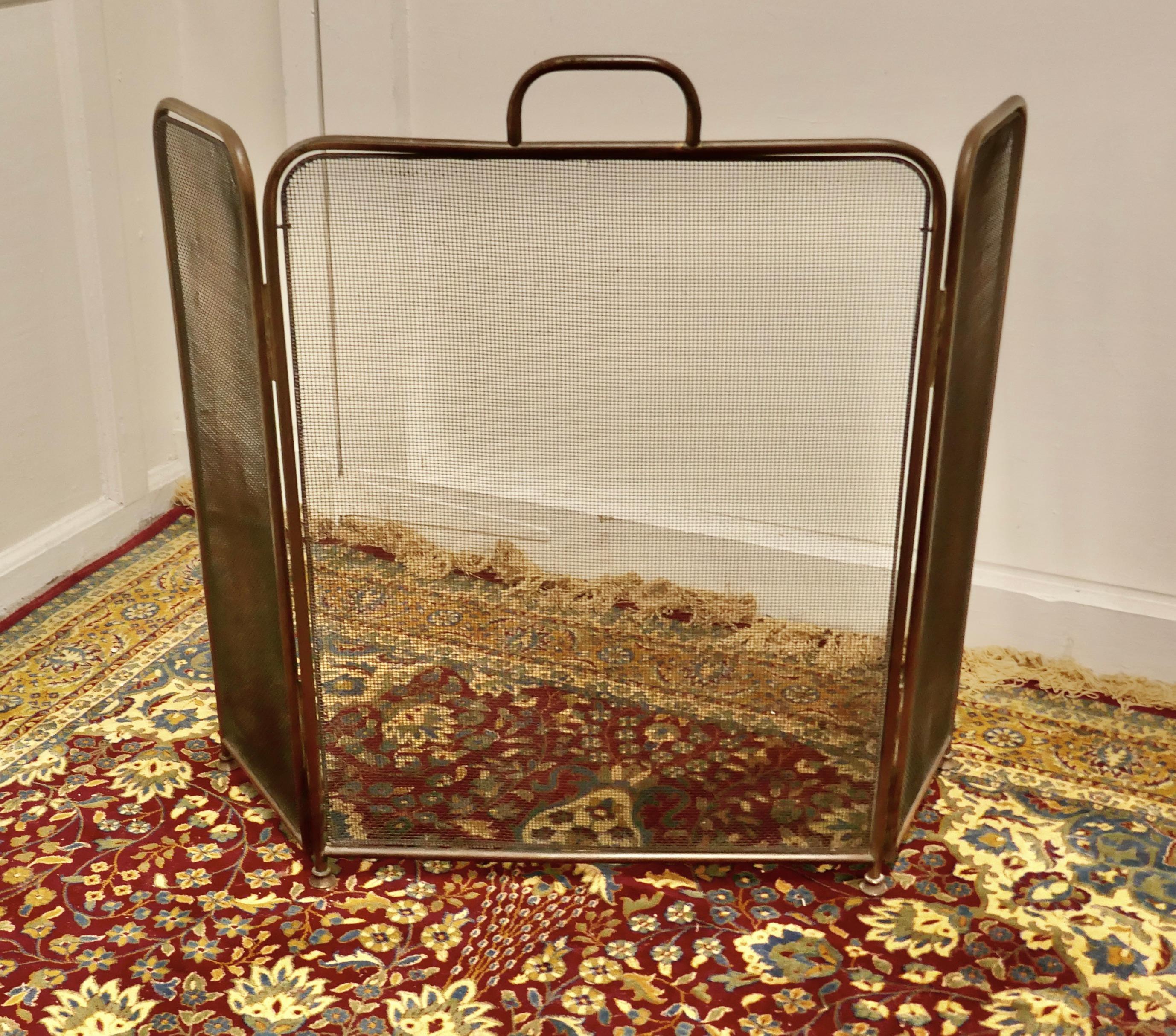 Large folding brass fire guard

This very useful spark guard has a brass frame and a fine mesh infill, it has the added advantage that it folds flat for storage, and when opened out it can be shaped to enclose your fire, very useful for a wood