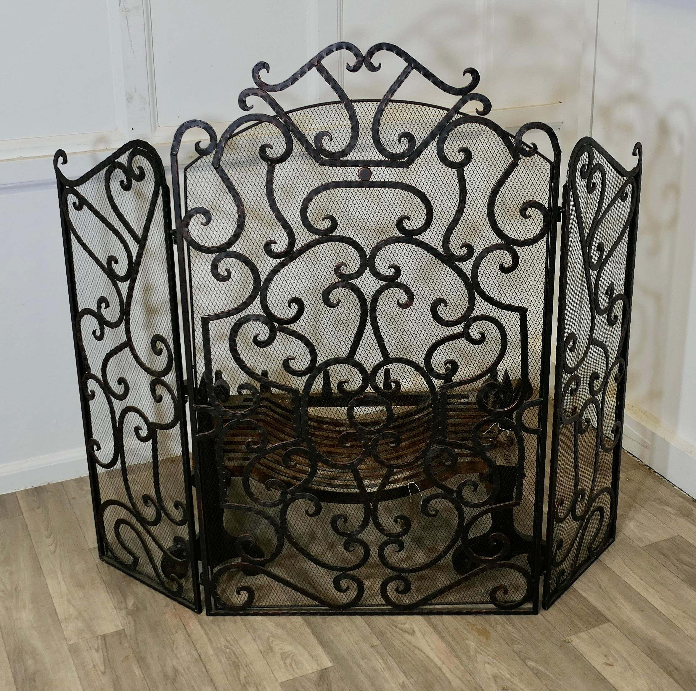 Large Folding Wrought Iron Fire Guard for Inglenook Fireplace

This is a good Fireguard, it would suit a traditional Inglenook fireplace or any fire 
The tall guard has a decorative wrought iron decoration with a heavy inset mesh behind
The guard is