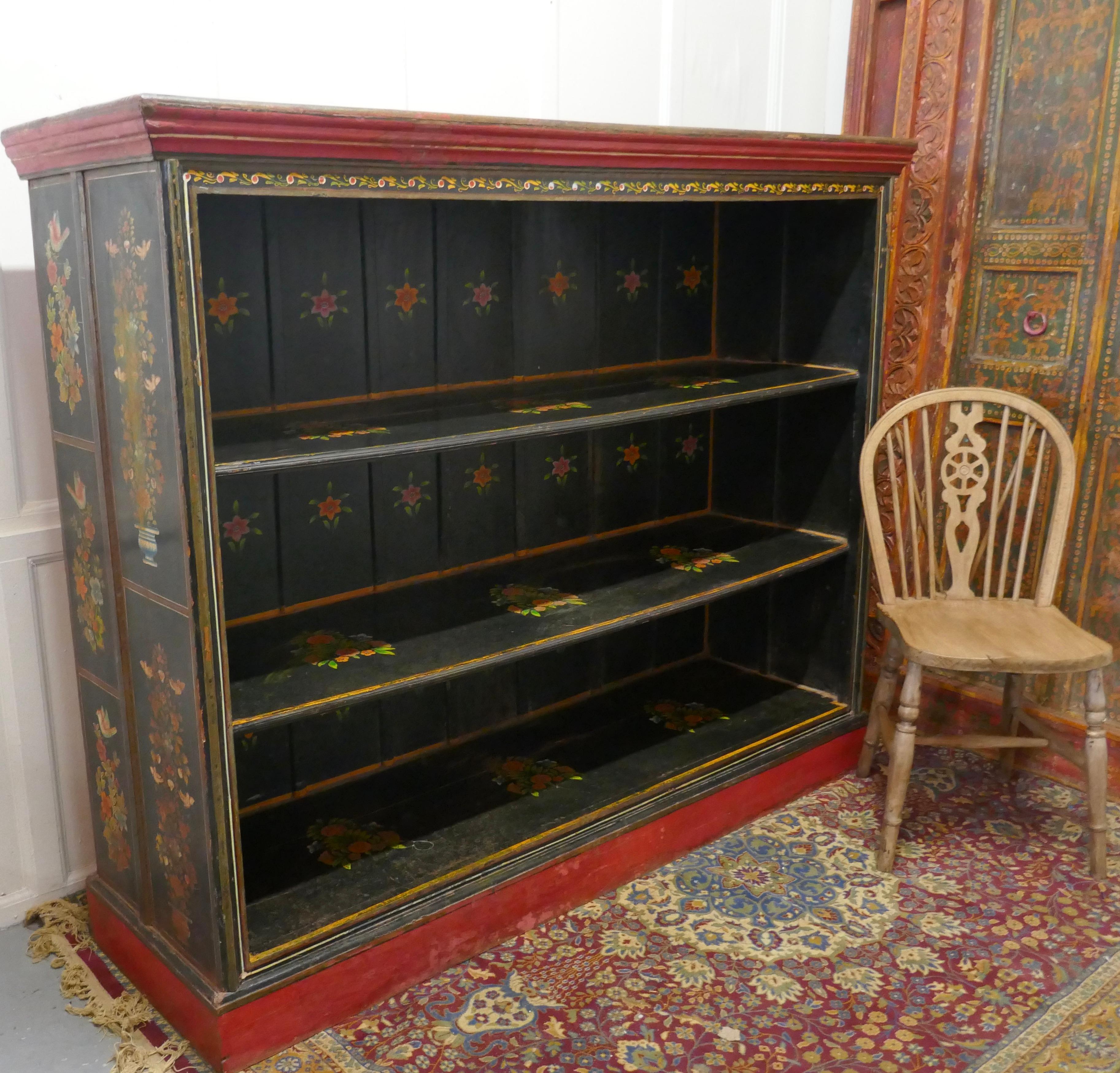 Large Folk Art painted open bookcase.

This is a larger than usual open fronted bookcase it is 20” deep
The bookcase is painted in the traditional colorful Folk Art Style with birds and flowers on a black background and it stands on a high