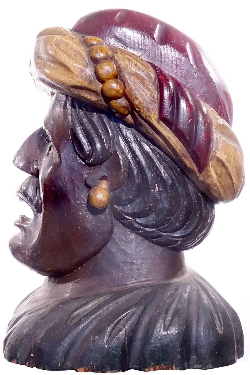 This large impressive early sales character was used the same way as a Cigar Store Indian. It shows a Moor's character head to represent products from exotic places. It was carved from a solid block of wood and is in wonderful condition. The