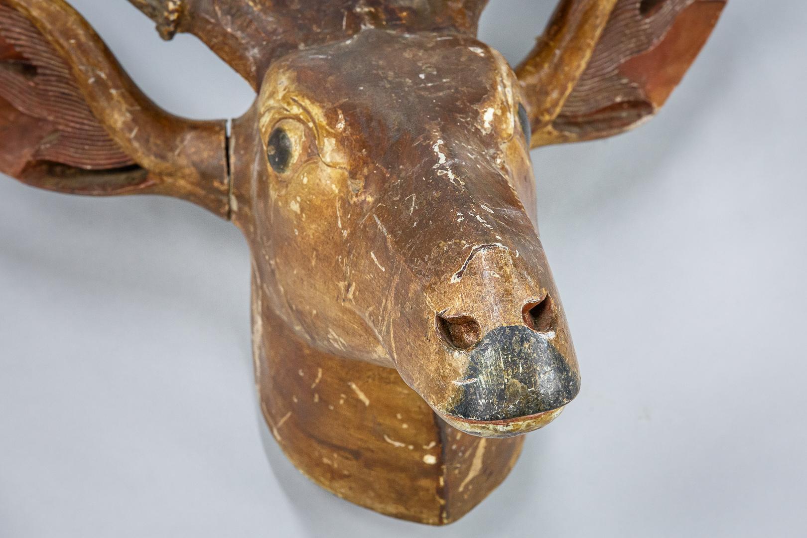 Large carved wooden deer trophy head, original painted finish, original mounted real red deer antlers, France, circa 1900.
Dimensions: 69cm x 100cm x 35cm.