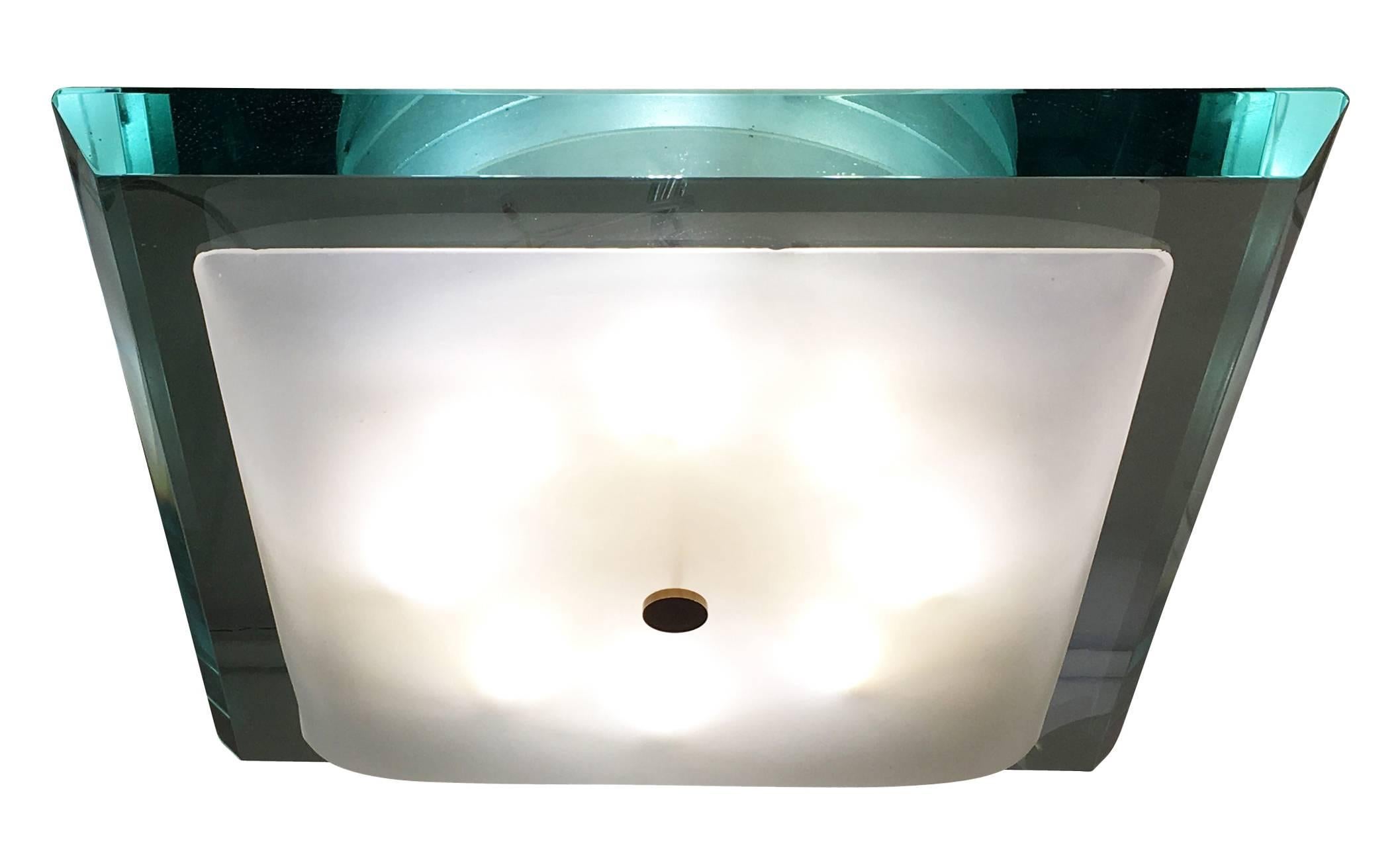 Stunning large Fontana Arte flush mount designed by Max Ingrand in the 1960s featuring a thick square glass. As typical of glass of the era it has a green edge which creates a beautiful emerald color when lit or seen from certain angles. The eight