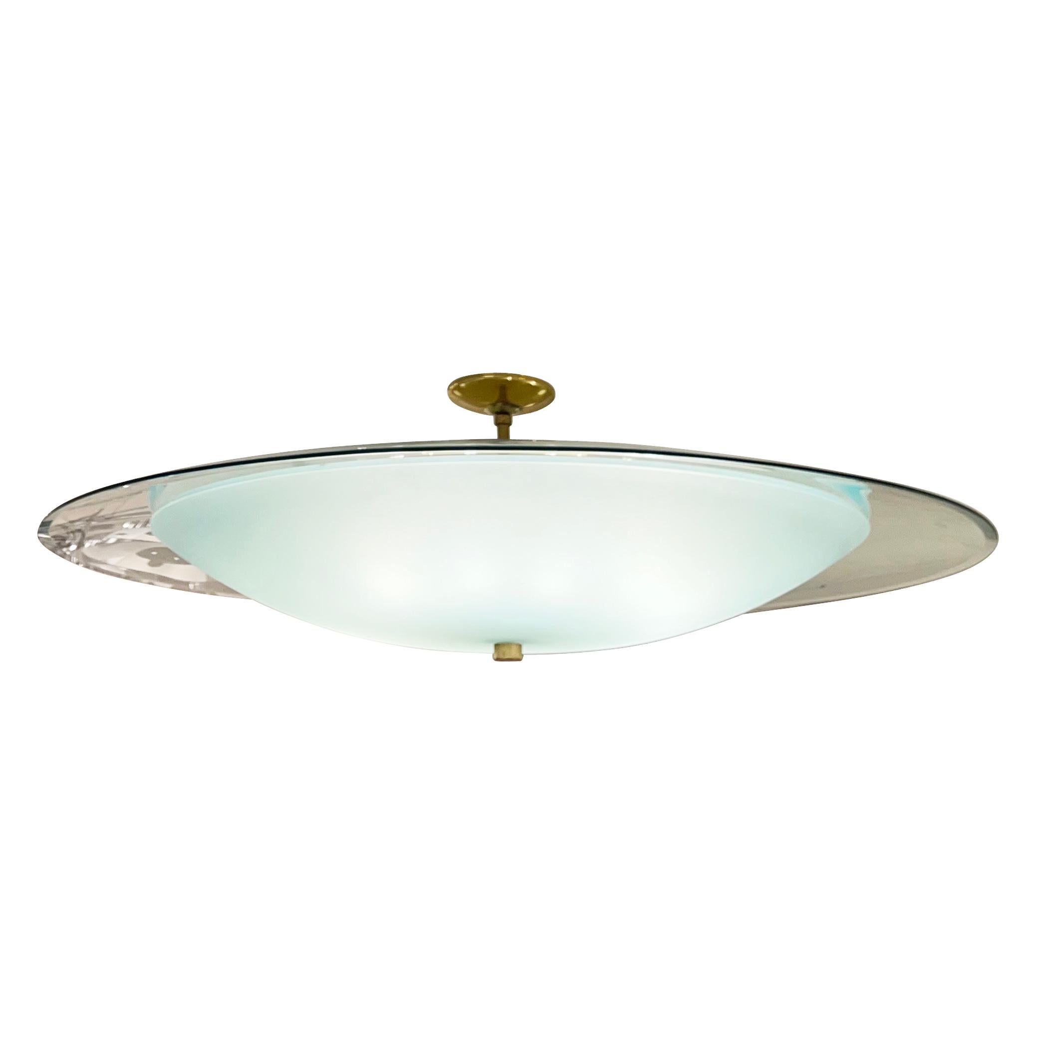 Large Italian mid-century chandelier in the style of Fontana Arte. The lower glass shade is frosted with a light green tint while the larger upper shade is clear. Nice detailing in the bevels of both glasses. Brass hardware and holds twelve