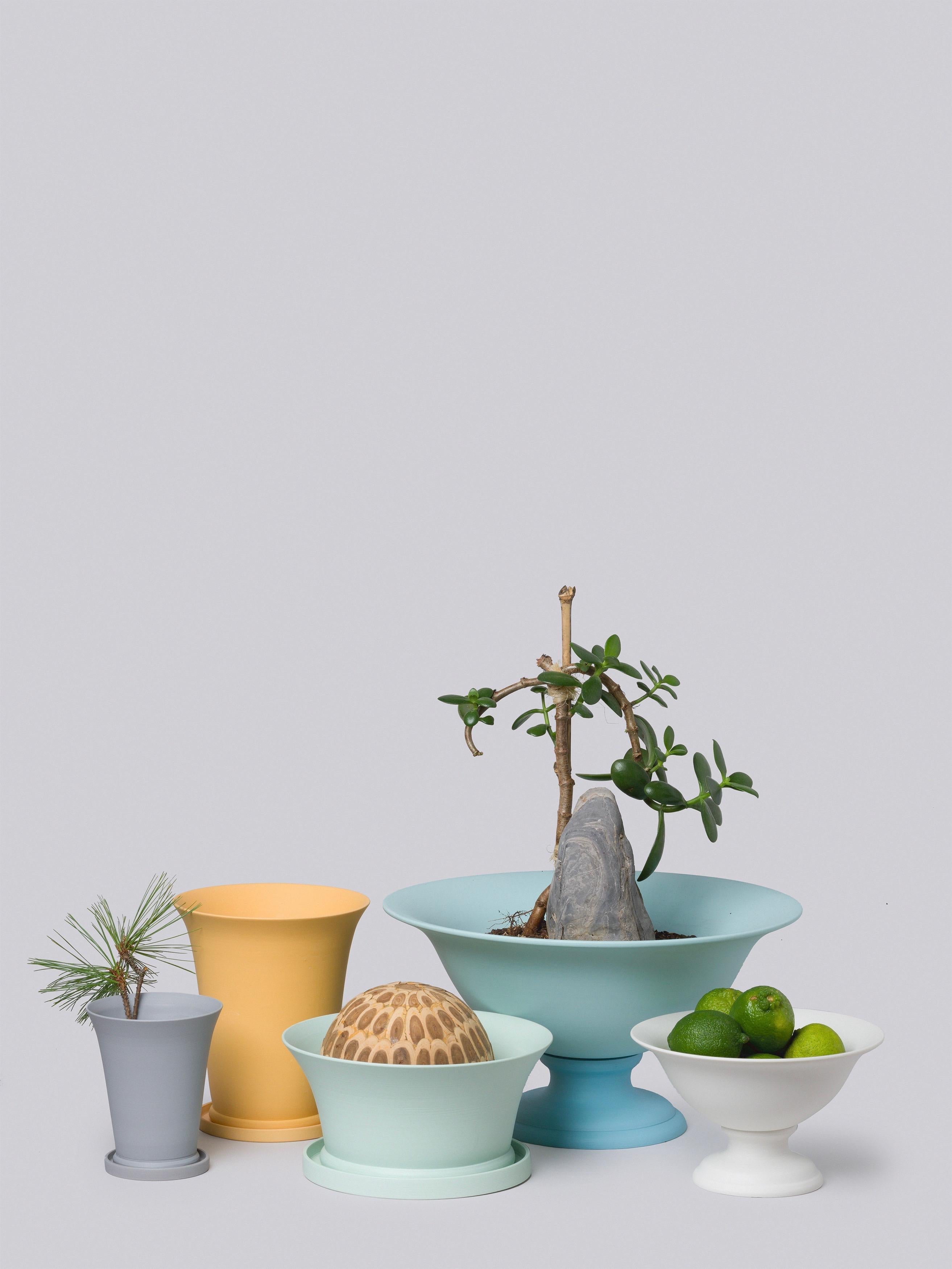 Middle Kingdom garden vaso are modeled after traditional terra cotta wares but are made from pigmented porcelain. The bowl can be moved from the base for planting and watering. The Classic, elegant style of this planter belies its supreme