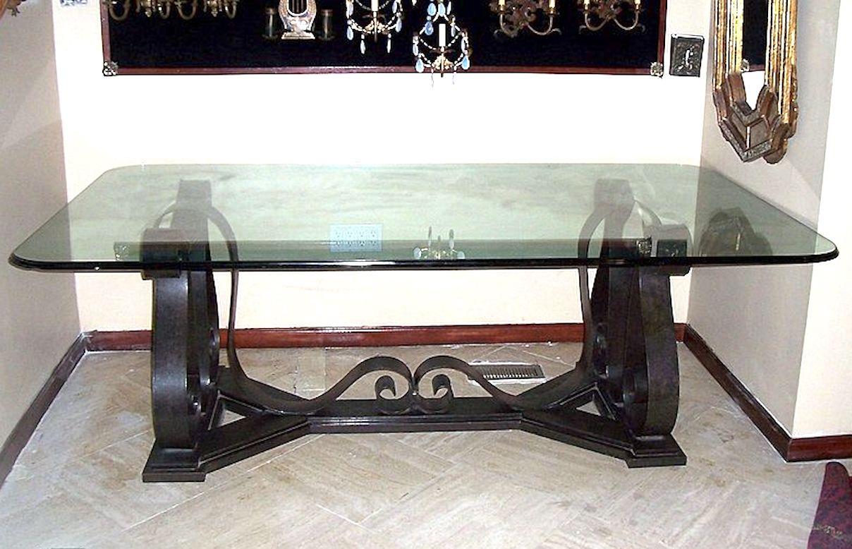 A large circa 1940's Italian forged iron dining table with glass top, scrolling legs and original patina.

Measurements:
height: 31.5