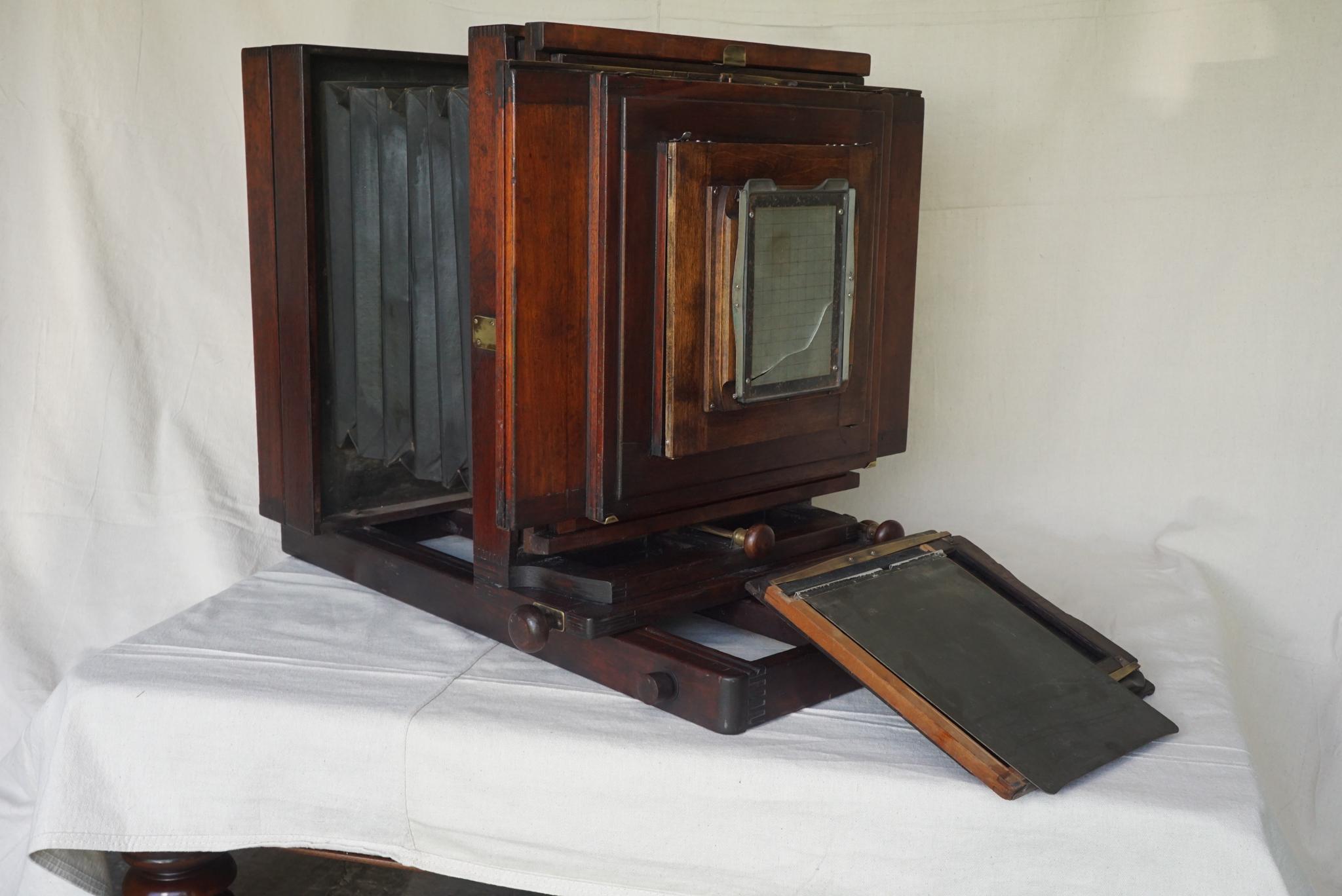 This large format box camera was made by the Folmer & Schwing Division of Eastman Kodak in Rochester NY. The case constructed of mahogany in a rich old red finish has many original details and was being used as a working camera until around 1960.