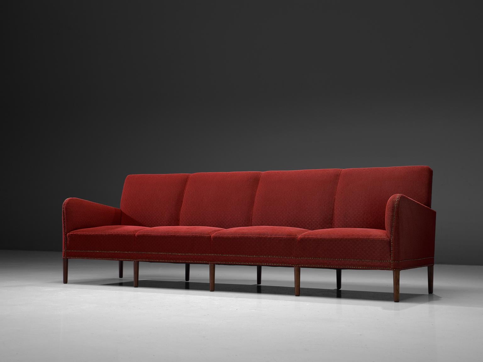 Lars Larsen & Jacob Hermann, four-seat sofa, fabric, mahogany, brass, Denmark, 1940s

This large sofa is made by Danish cabinetmakers Lars Larsen & Jacob Hermann. The sofa is standing on small legs executed in mahogany. The seat is visually