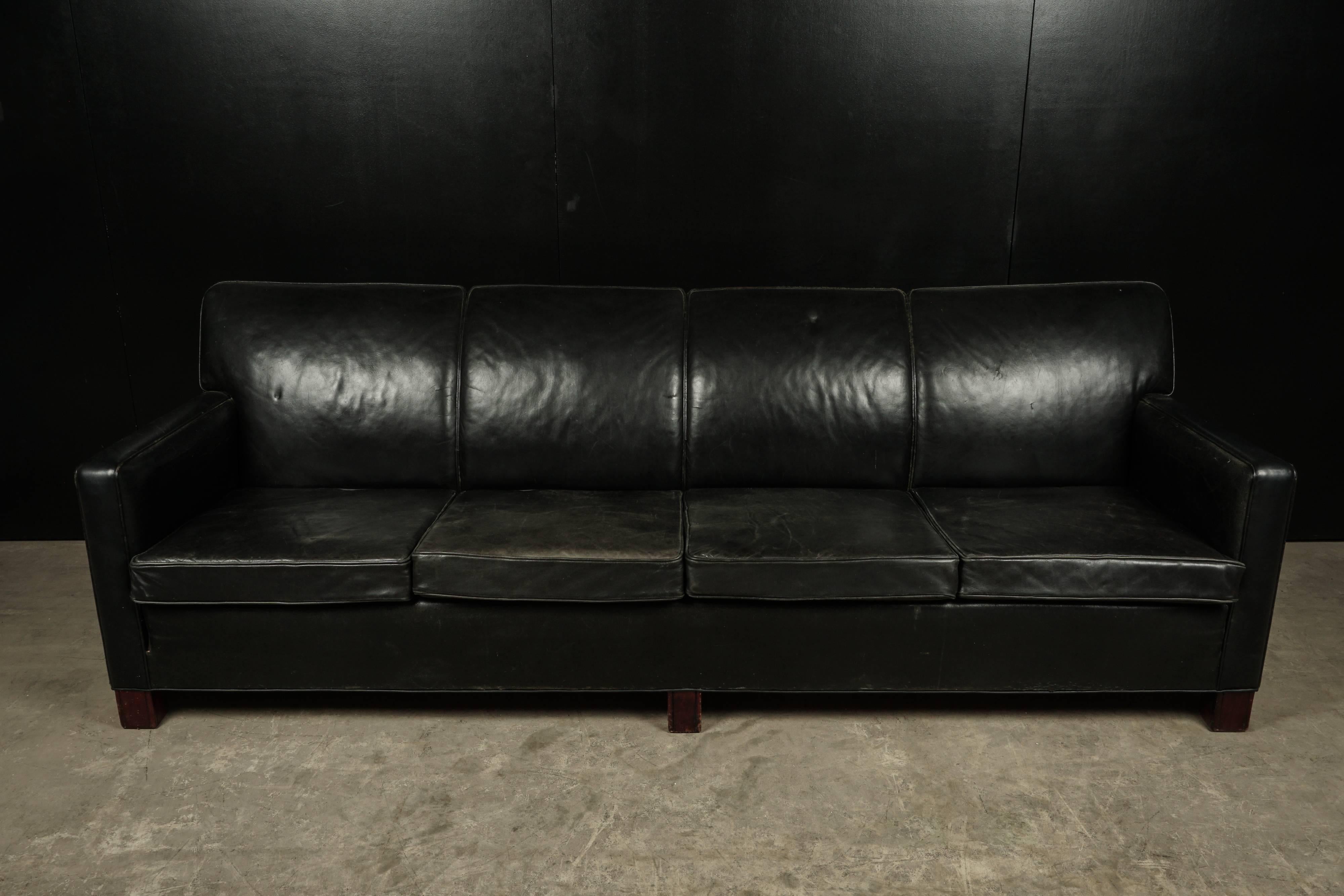 Large four-seat leather sofa from Denmark, circa 1950. Danish cabinet maker, presumably designed by Flemming Lassen. Leather with nice patina and wear.
Measures: Seat height 18