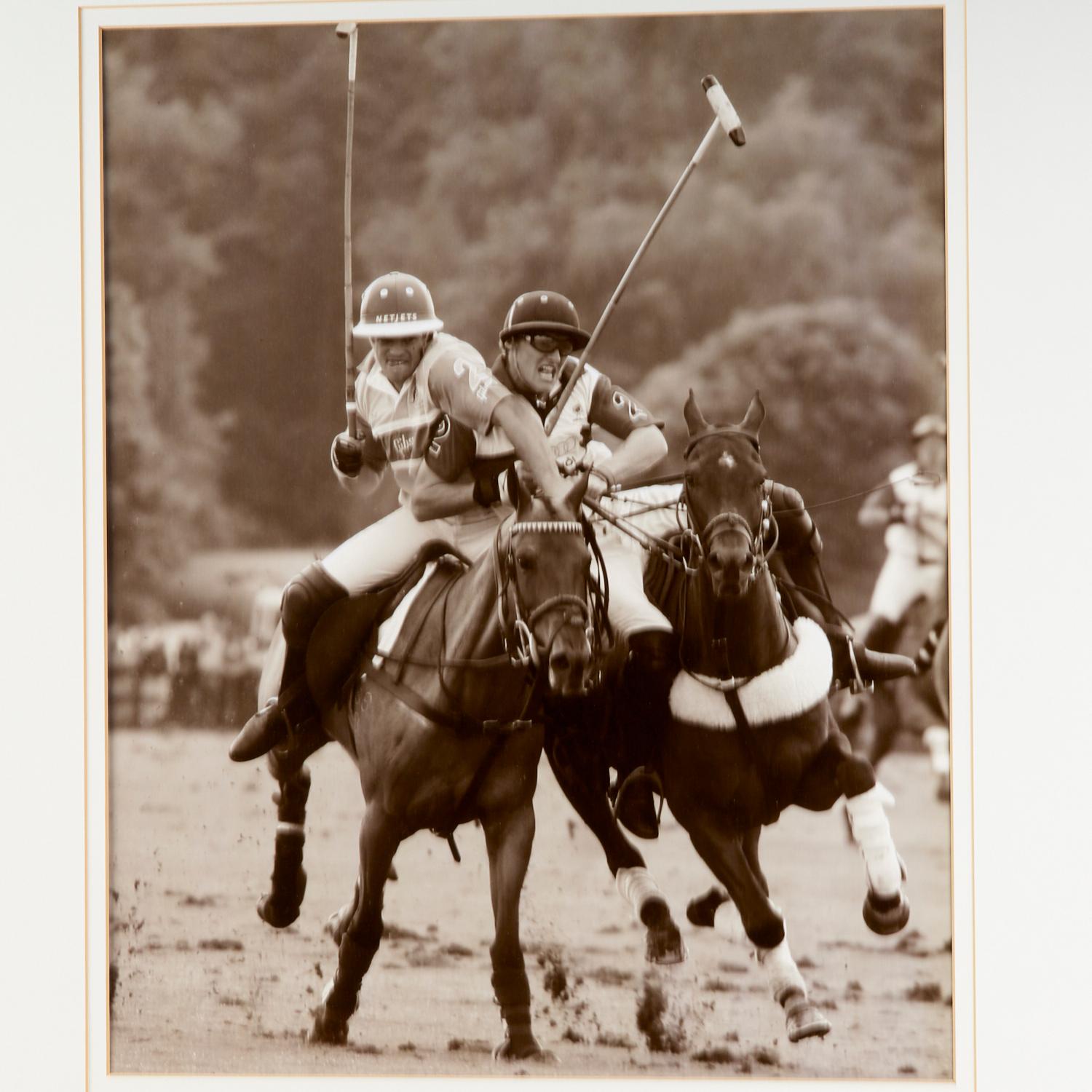 20th c., black and white photographic prints, matted and framed under glass. A pair of polo action shots that capture the intensity of play and the agility of player and polo pony alike.

Dimensions:
20.25