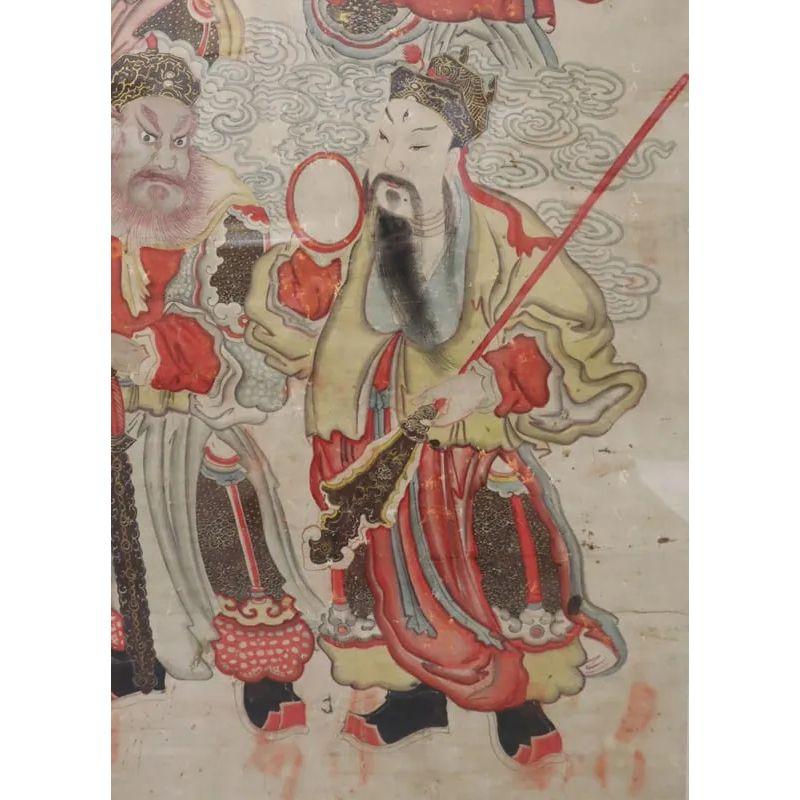 A framed Chinese watercolor on rice paper of four warriors.  The late 18th century painting depicts four defenders of Buddha, clad in red and black, each striking a different warrior pose, resting in a gold frame.  Panel without frame measures 30.25