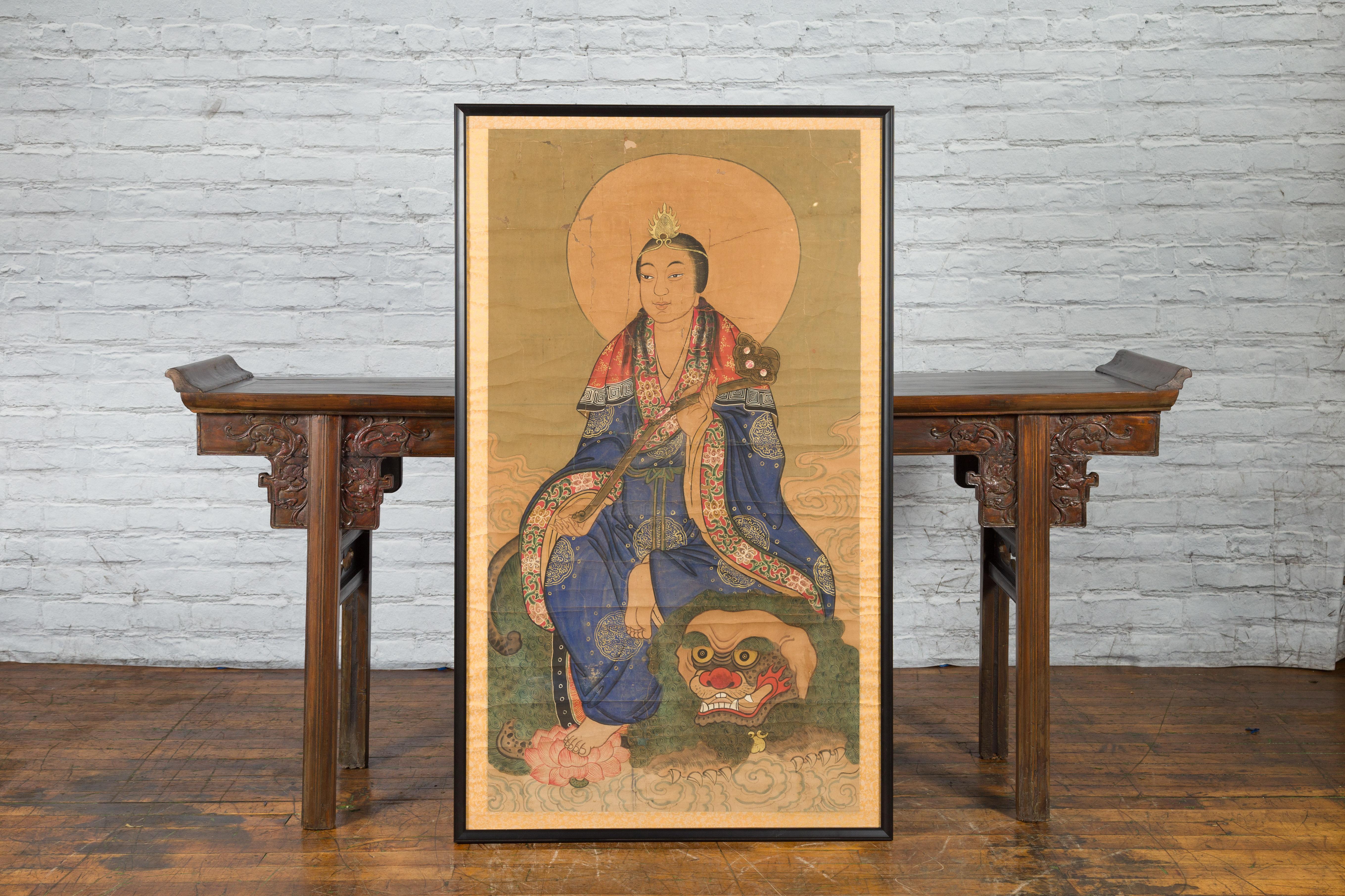 An antique Indian painting from the 19th century depicting Guanyin the Bodhisattva of Compassion sitting on a dragon. Created in India during the 19th century, this large painting features Guanyin the Bodhisattva of Compassion, sitting on the head