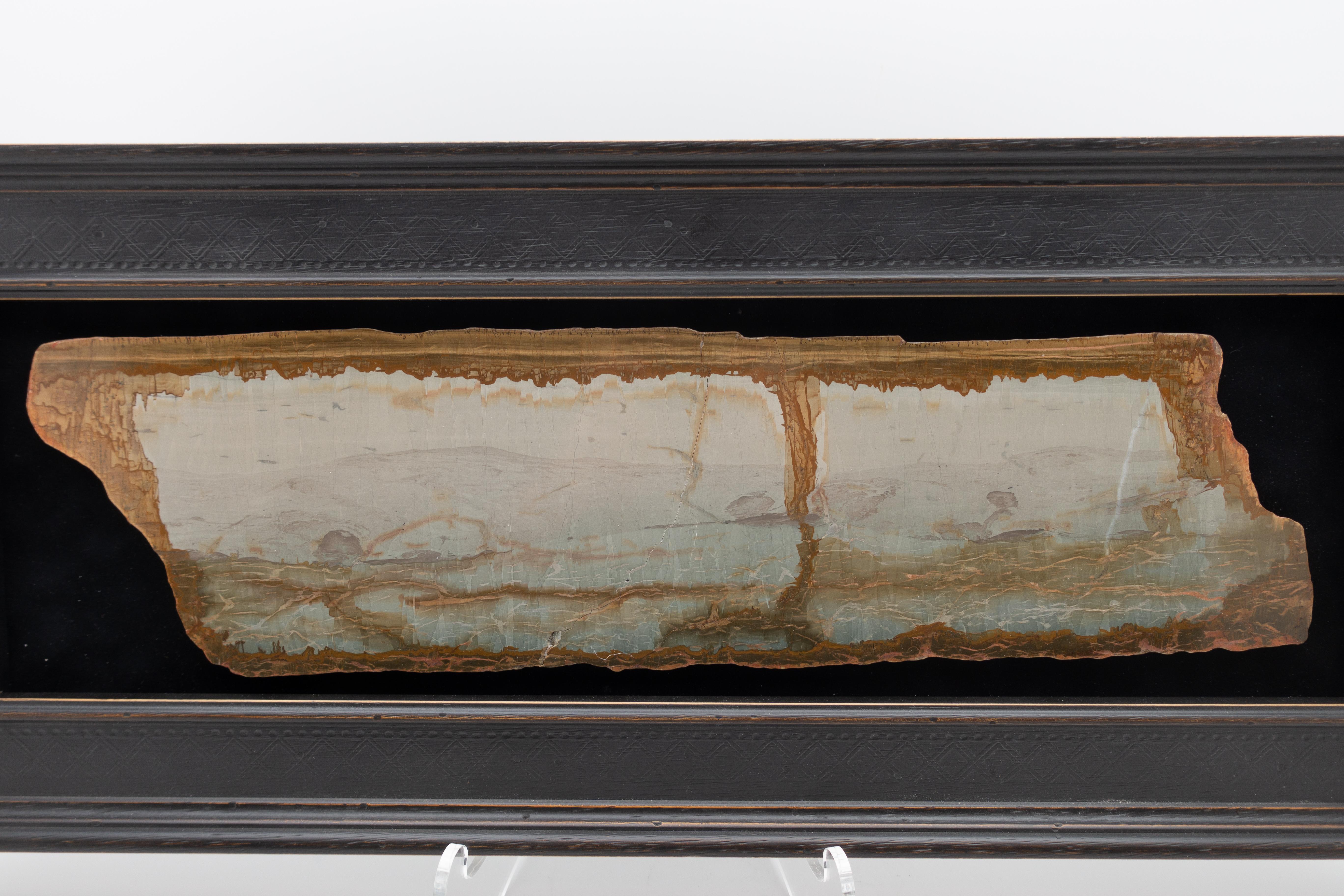 Framed slice of pietra paesina, also known as landscape stone or ruin marble. Pietra paesina is a kind of limestone or marble originating mostly from Florence territory, whose natural appearance gives the impression of a ruined landscape painting.