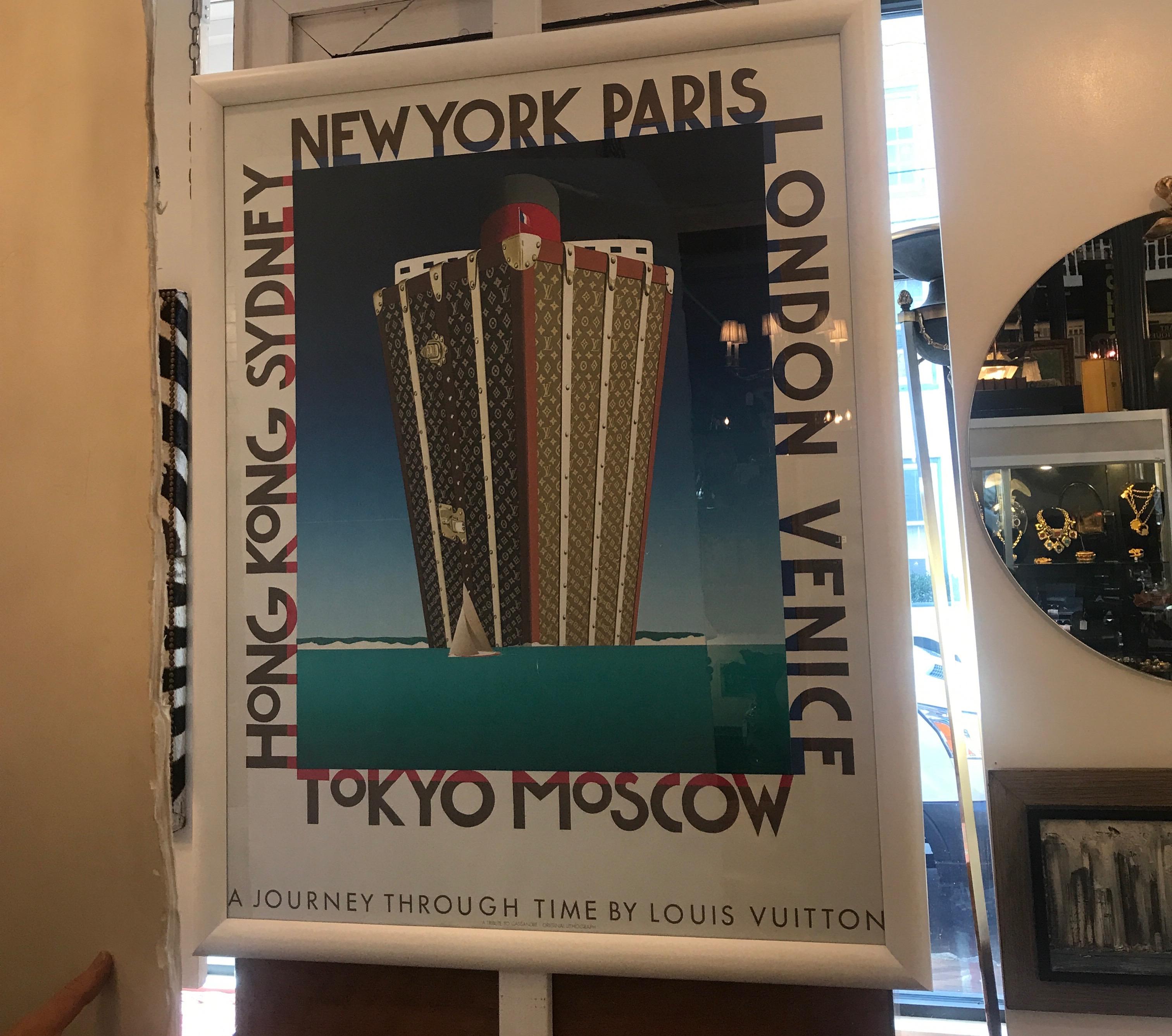 Stunning and vibrant authentic Louis Vuitton framed poster. The white lacquered hardwood frame with UV glass highlight this very chic late 1970s Vuitton poster...