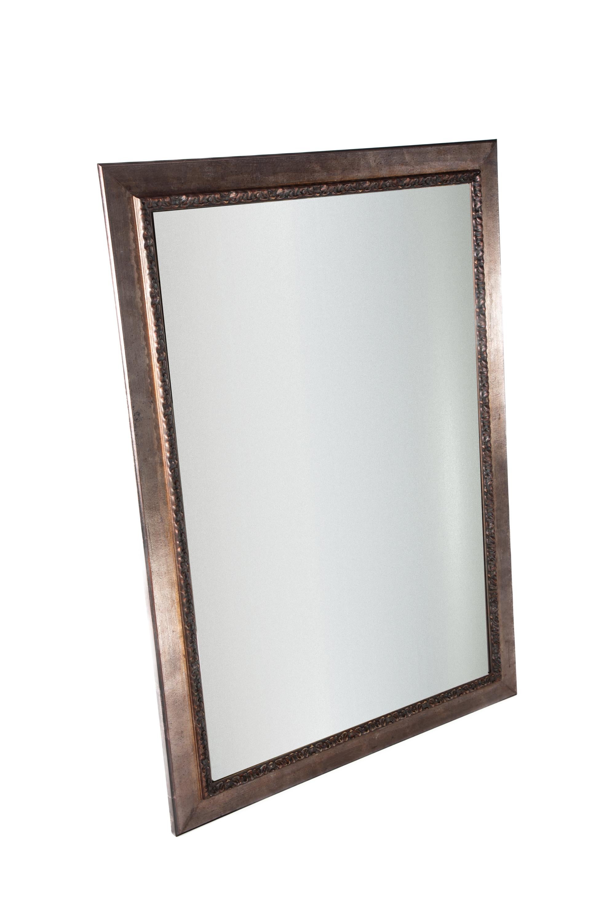Large wall mirror in decorative frame.