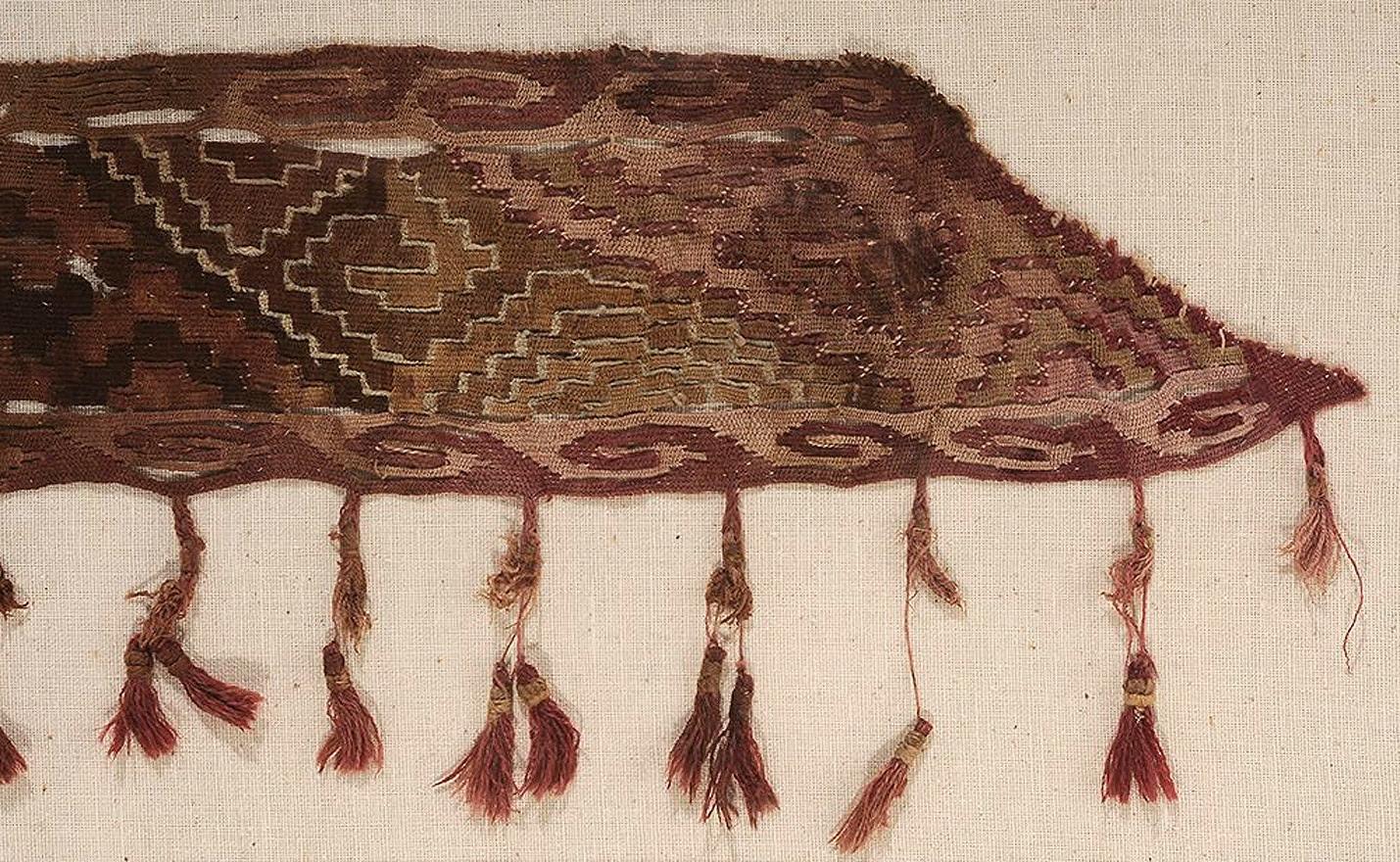 A fragment of antique Peruvian textile from Pre-Columbia era, nicely displayed in a matted metal frame. Likely from Chancay culture in Central coast of Peru that thrived in the late Intermediate Period/ late Horizon, A.D. 1200-1550, the tasseled