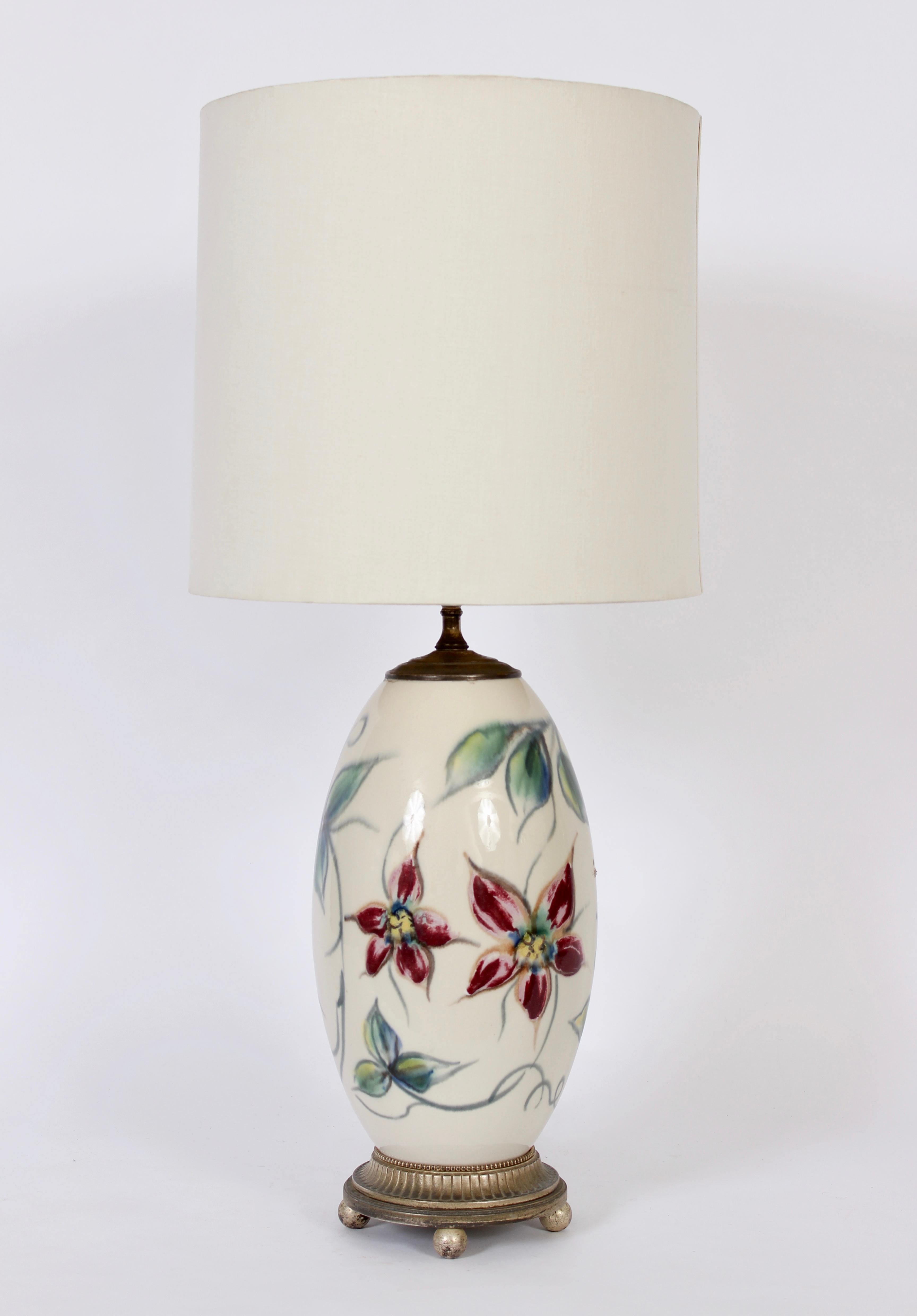 Single Tall Vontury Inc. hand painted floral and leaf porcelain table lamp, 1950s. Featuring a porcelain forn in Antique White with hand painted burgundy, pink and yellow flowers painted and vine like stems in green tones including sea green, teal.