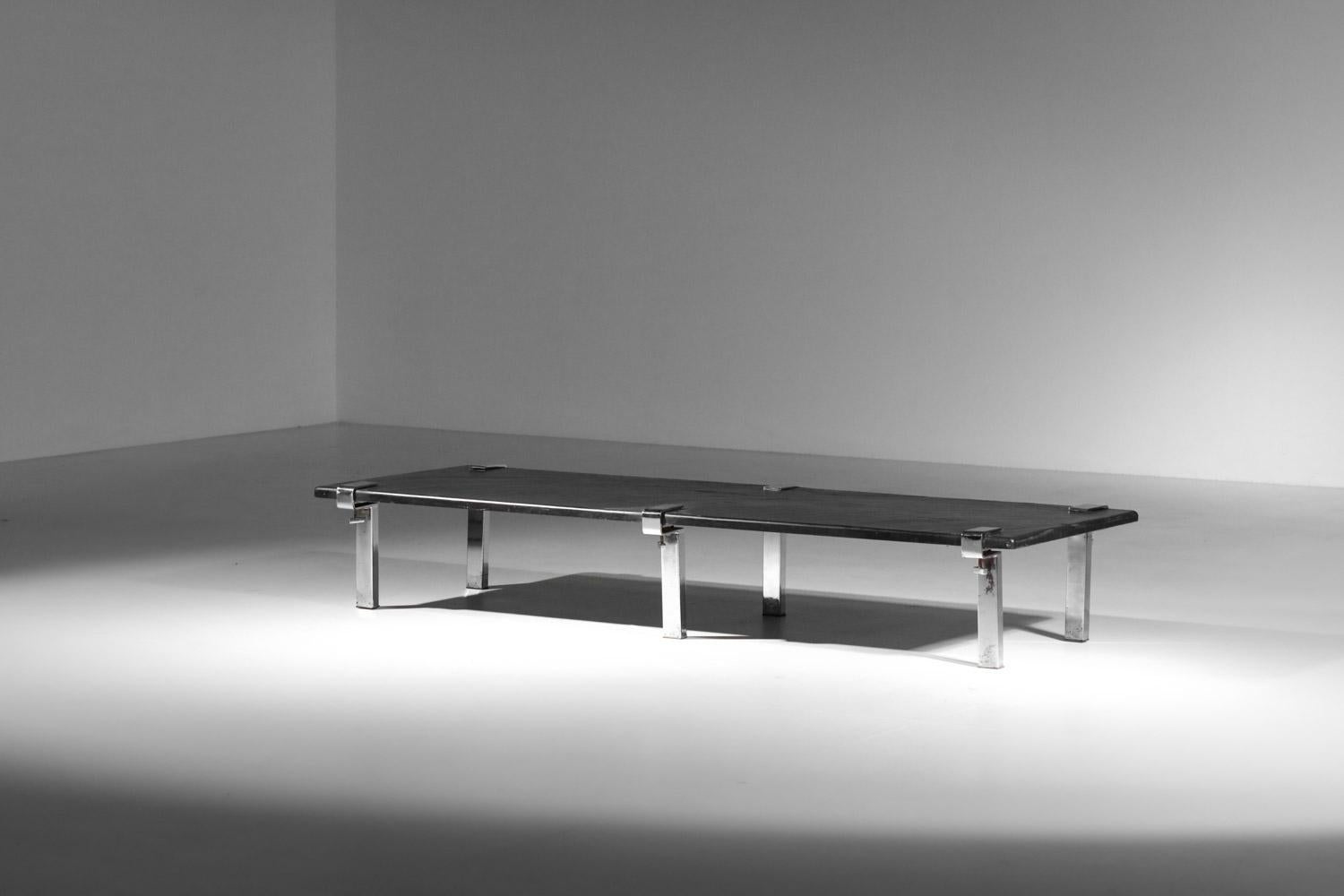 Large 60's coffee table by designer François Arnal. Top in solid slate (rather heavy) and 6 clamp-like legs in the designer's typical chromed steel. Sober, elegant design. Beautiful vintage condition, with traces of age and use on the top: