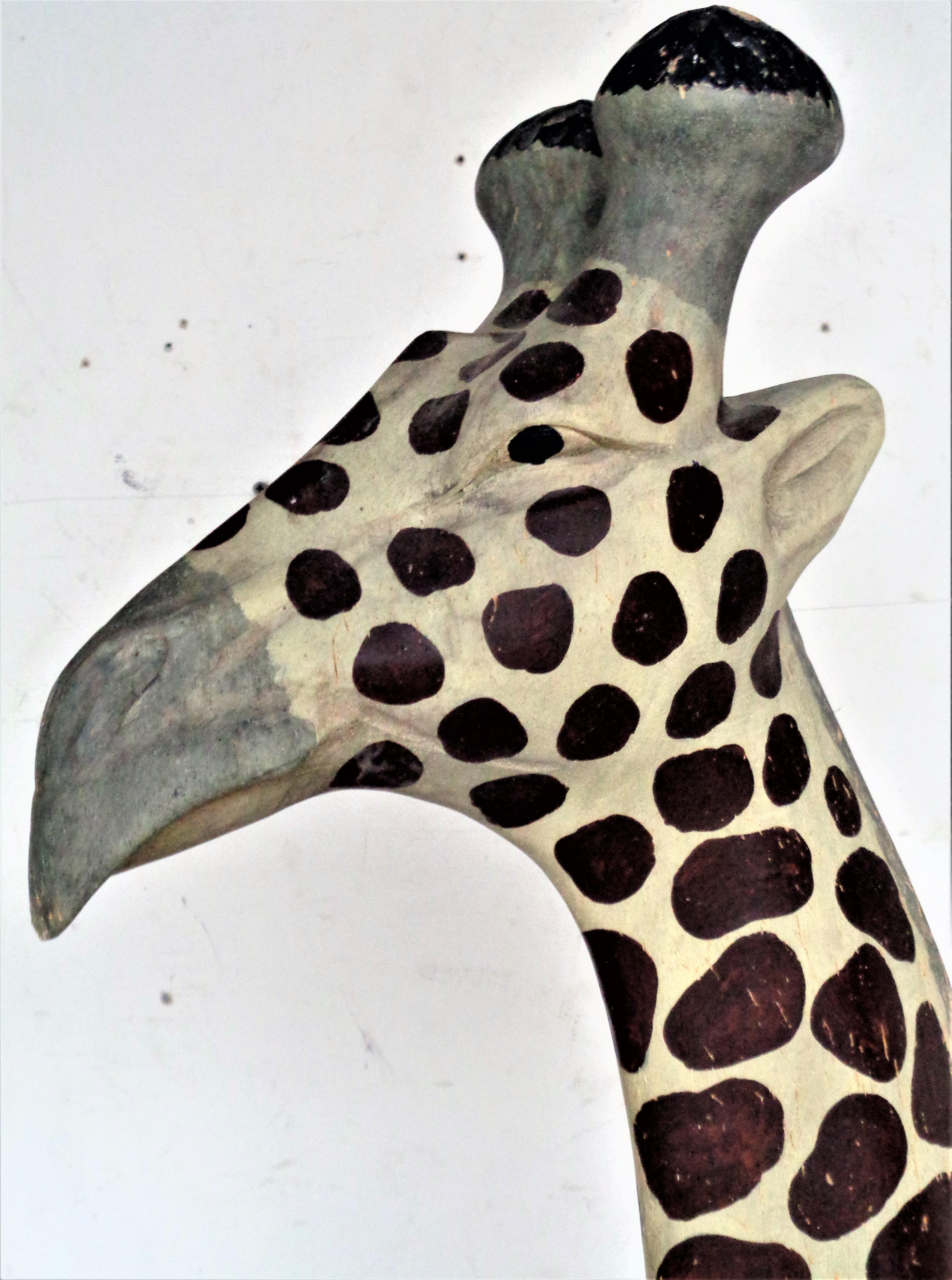 Large free standing wood giraffe with beautifully aged original polychrome painted surface. An exceptionally fine life like detailed carving with great facial expression. Measures 61