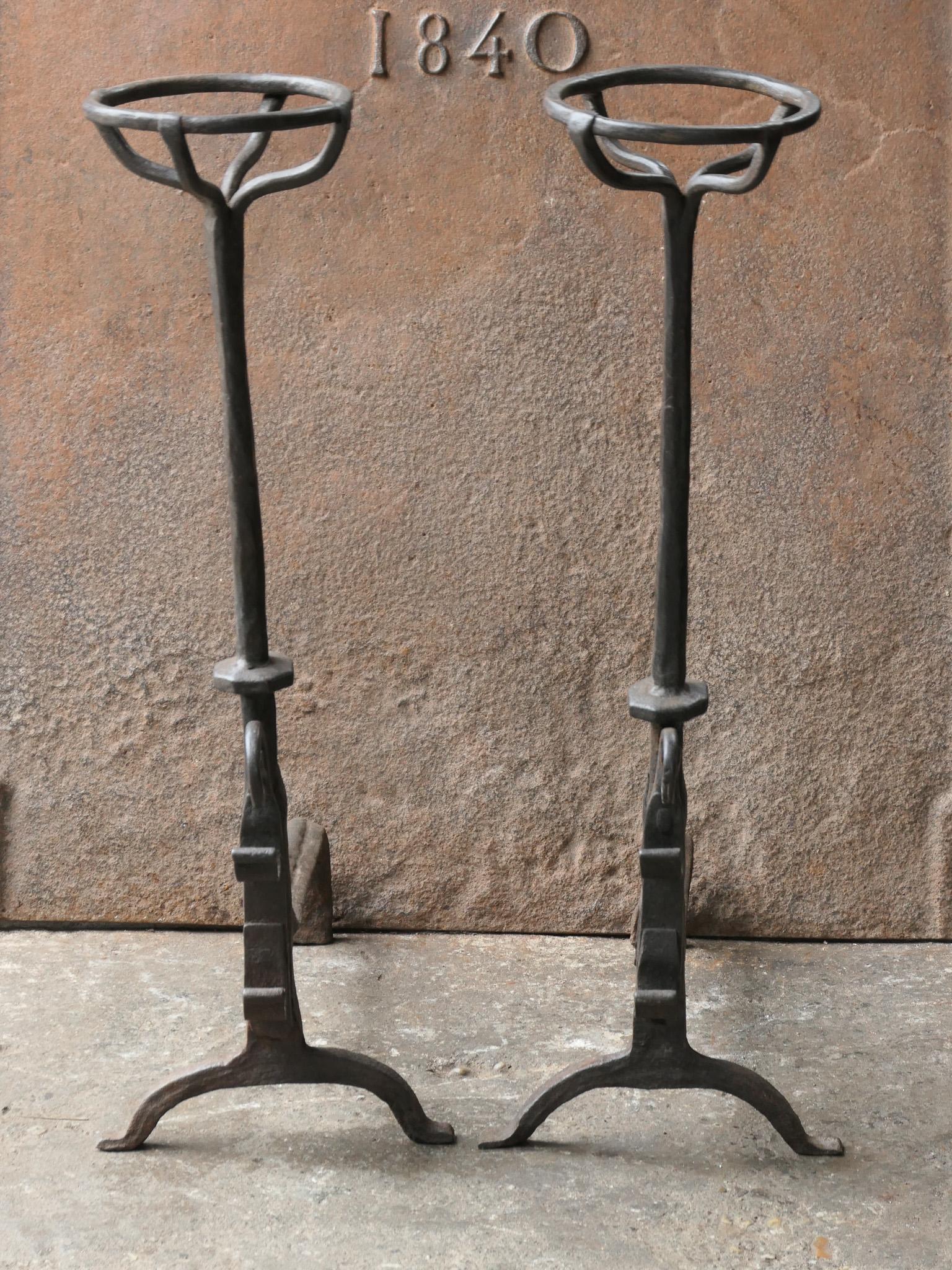 17th century French gothic andirons - fire dogs made of wrought iron. These French andirons are called 'landiers' in France. This dates from the times the andirons were the main cooking equipment in the house. They had spit hooks to grill meat or
