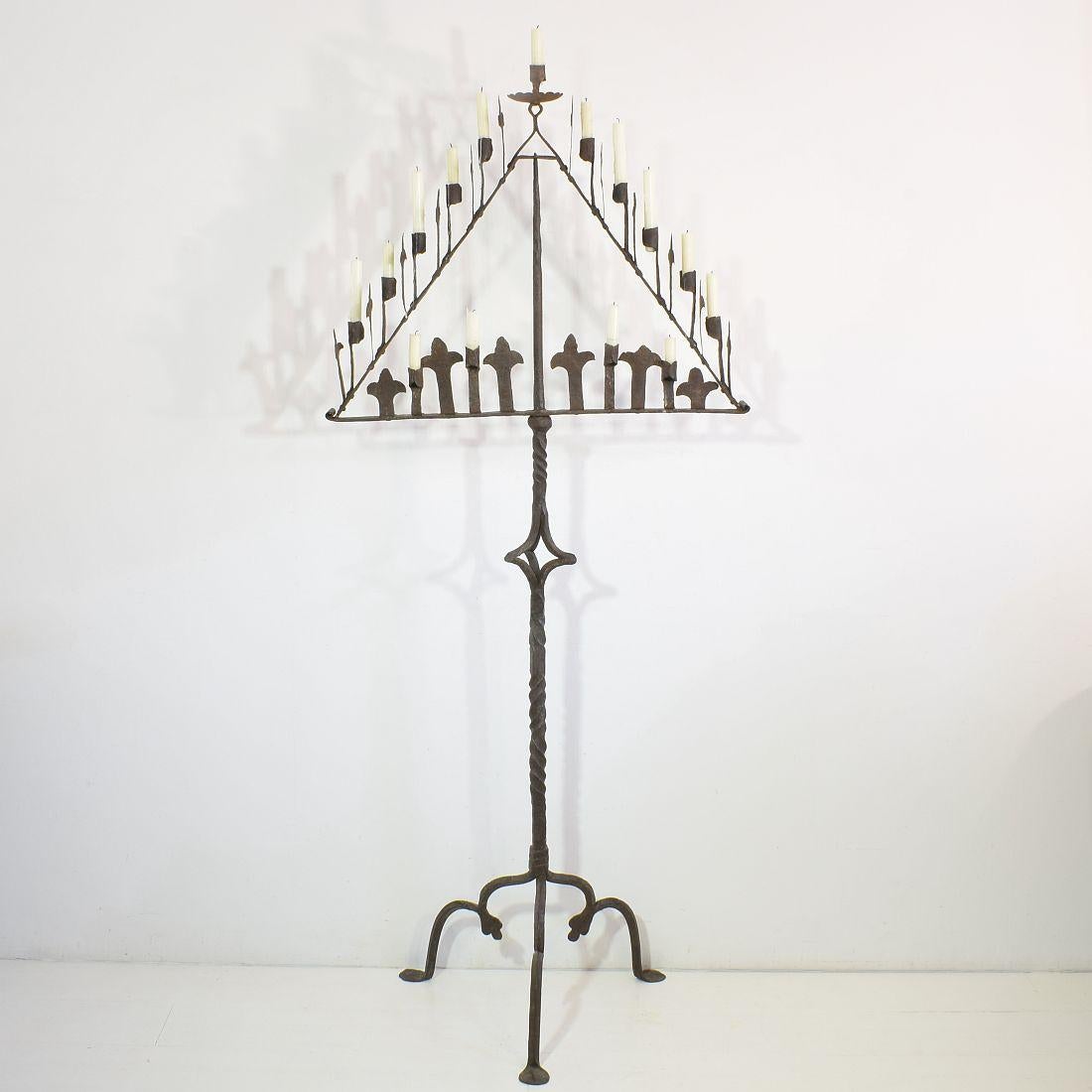 Wonderful hand forged Iron candleholder in Gothic style. 
Although the Gothic period was already over this style stayed popular for a long time in the French country side.
Very beautiful detailed with French Fleur de lyse ornaments. The Fleur de