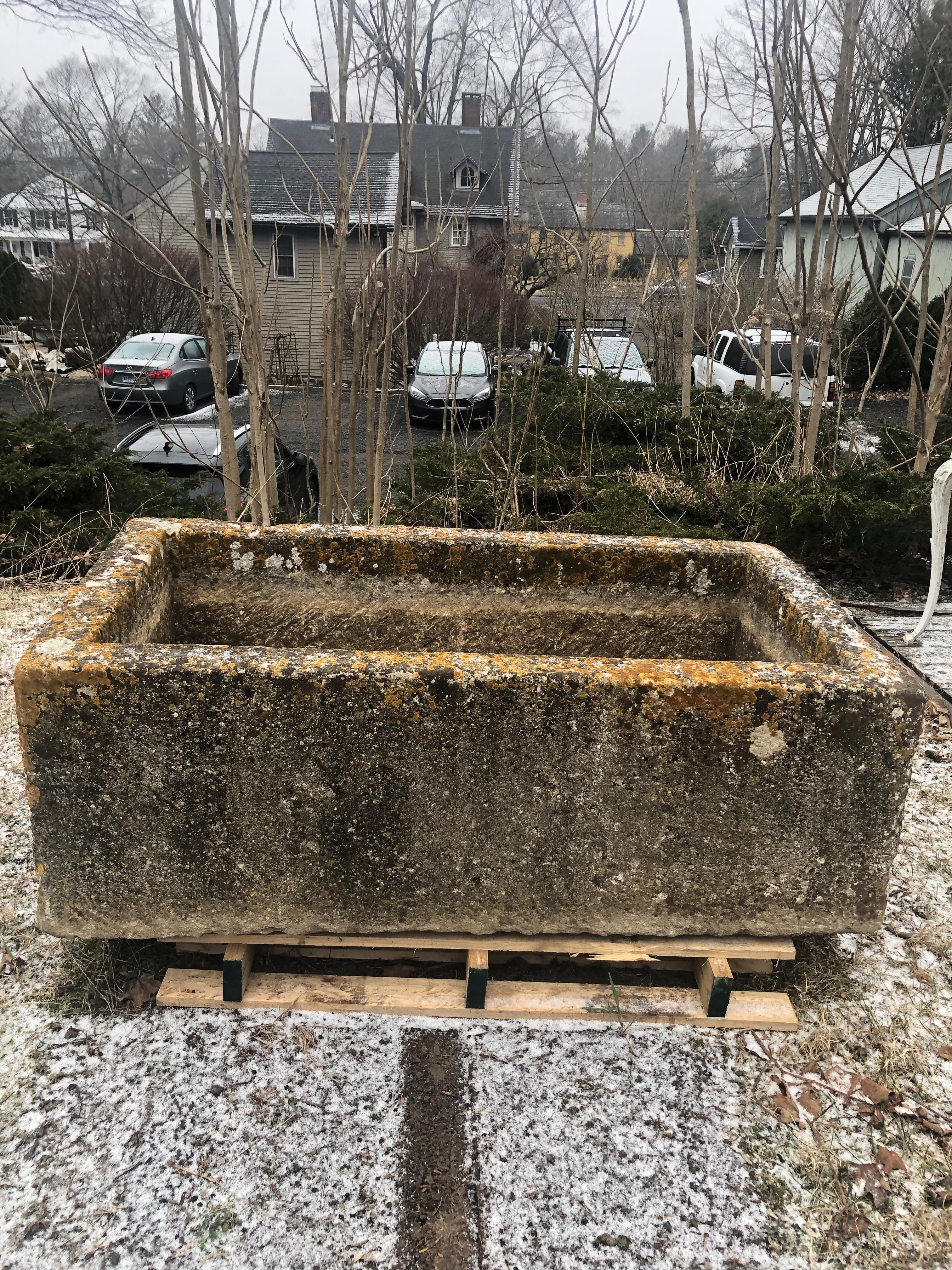 One of the finest troughs sourced on our most recent buying trip to France, this stunning hand carved limestone trough is in excellent antique condition and features a fabulous patina with heavy lichen in white, yellow and orange. It has no cracks