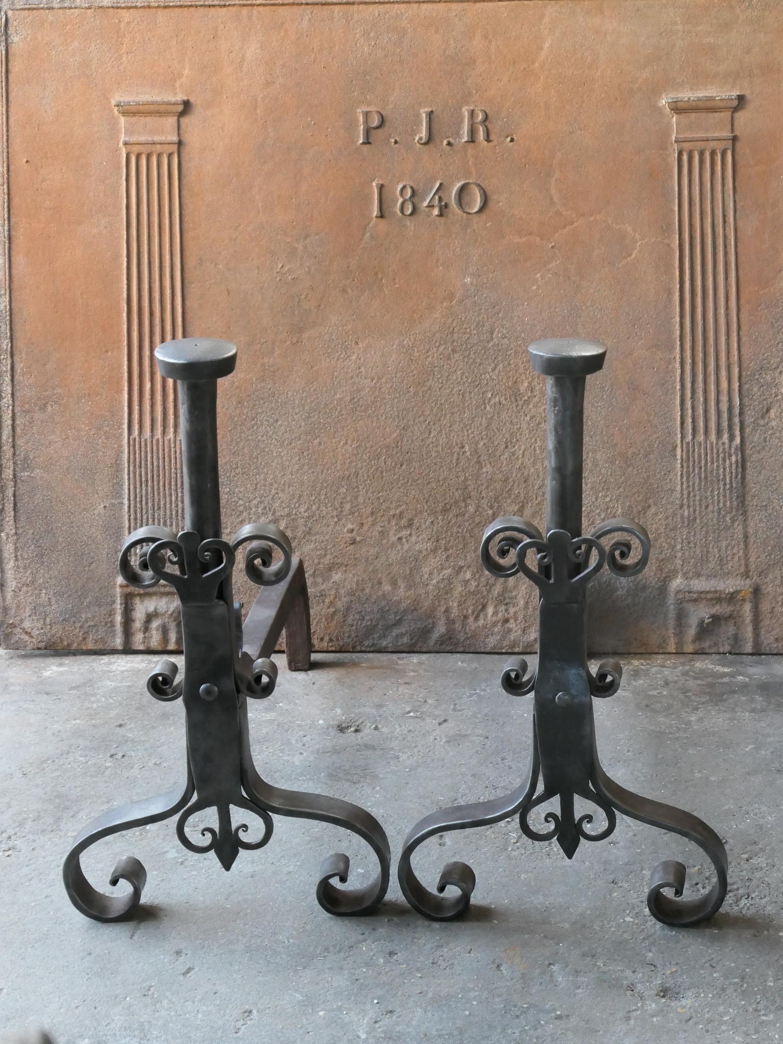 18th century French andirons - fire dogs made of wrought iron. These French andirons are called 'landiers' in France. This dates from the times the andirons were the main cooking equipment in the house. They had spit hooks to grill meat or poultry