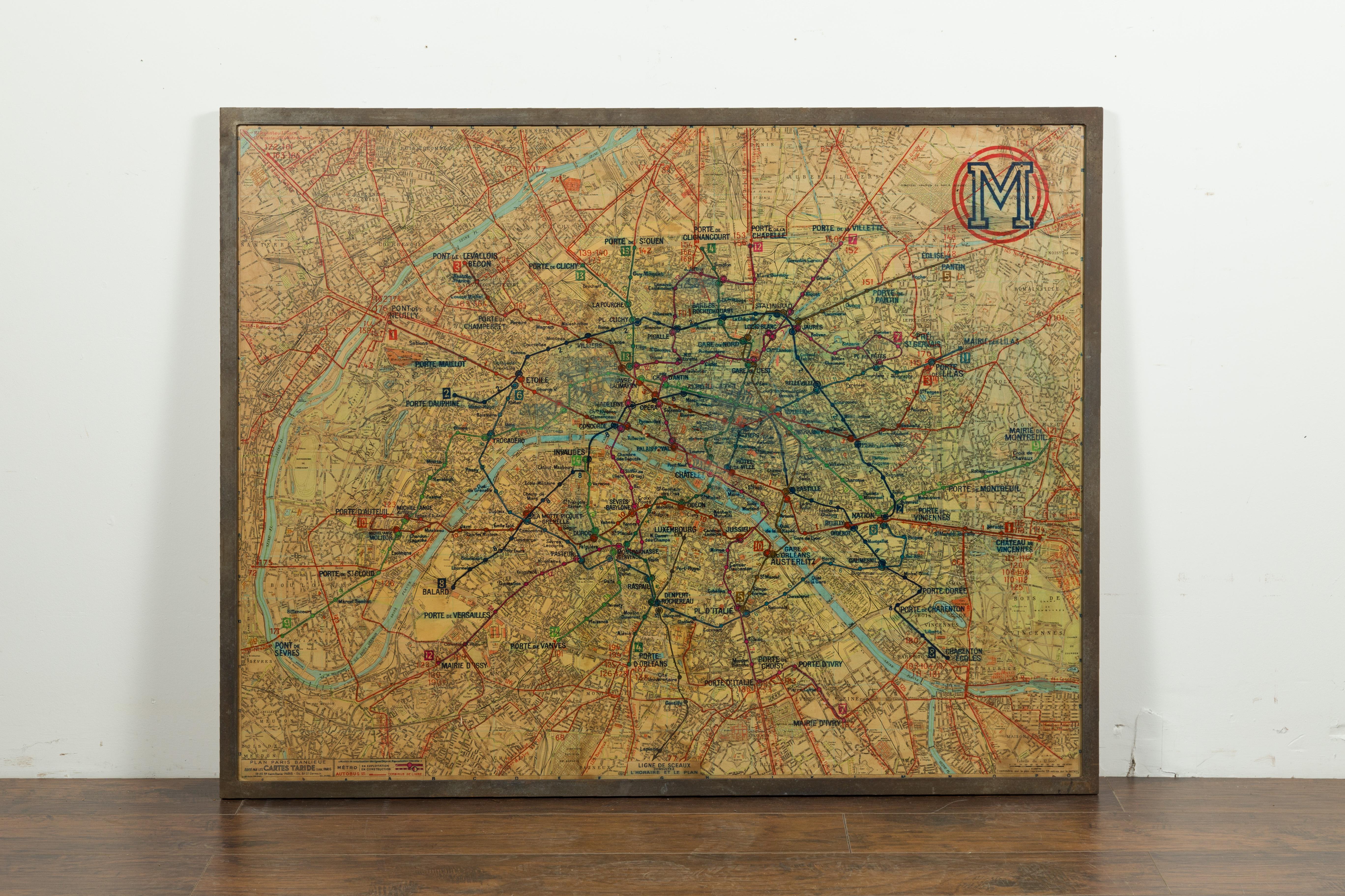A large French framed map of the Parisian Metro from the mid-20th century, with custom iron frame. Featuring a Paris metro map from the midcentury period, this wall piece is set in a custom iron frame. Showing a nicely worn appearance, the map