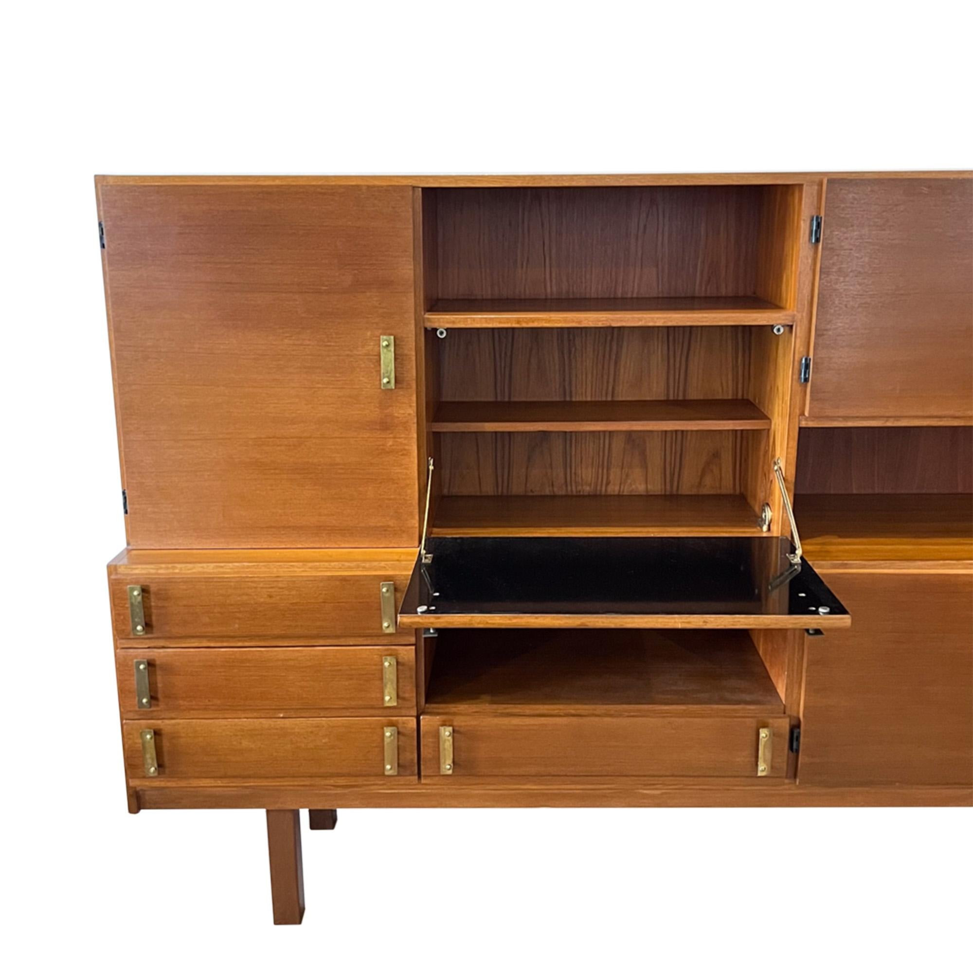 This impressive piece was made in France in the 1960s.

A great combination of storage and display space, including a pull down home bar. Please have a look at all our pictures to take a look. 

An attractive design with the decorative original