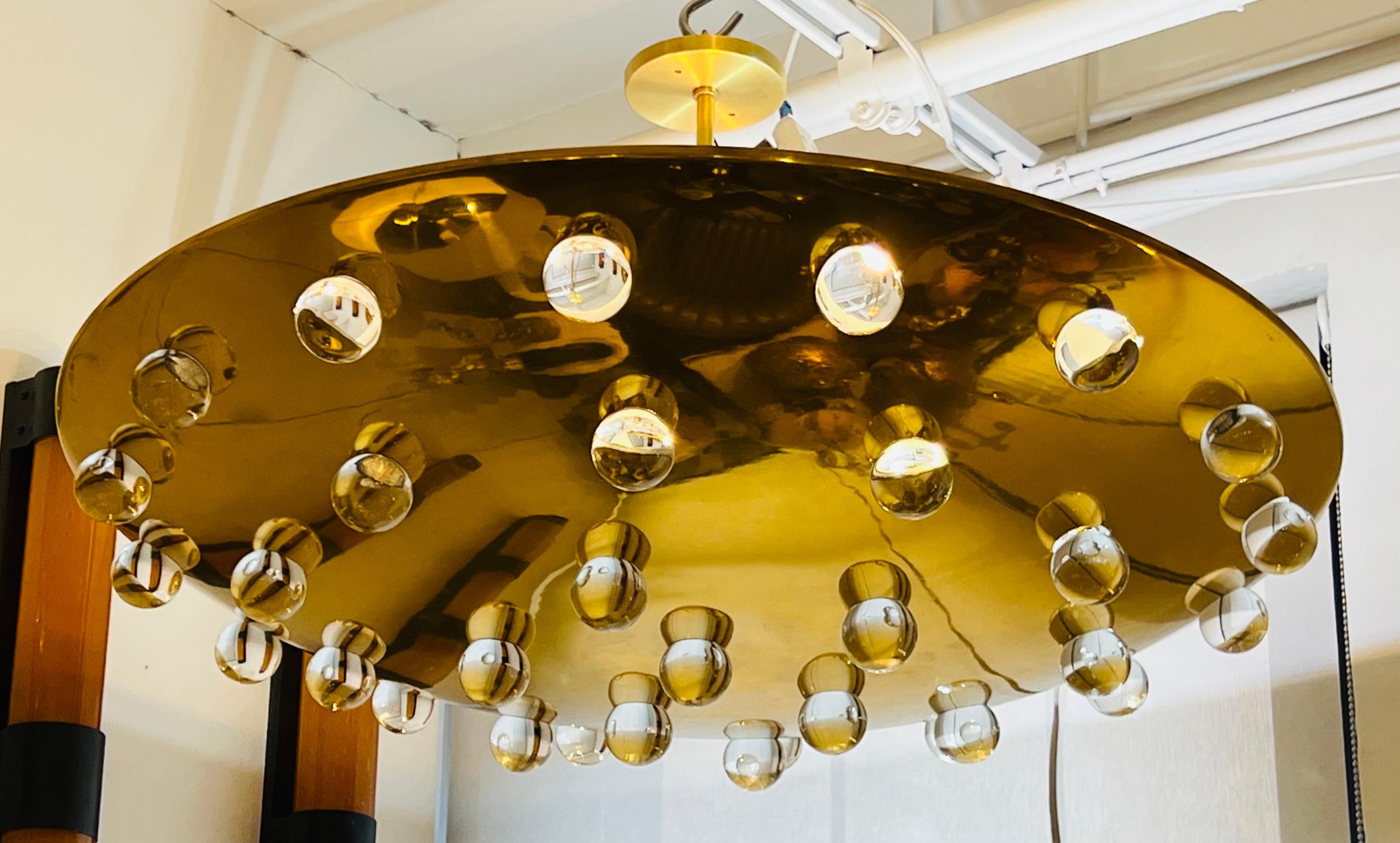 A rare very large 1960s high polished golden shallow bowl with 32 solid crystal glass orbs to emit light. The interior is white enamel and has 4 Starr A sockets. Completely rewired and restored. The ceiling pole can be cut to make closer to the