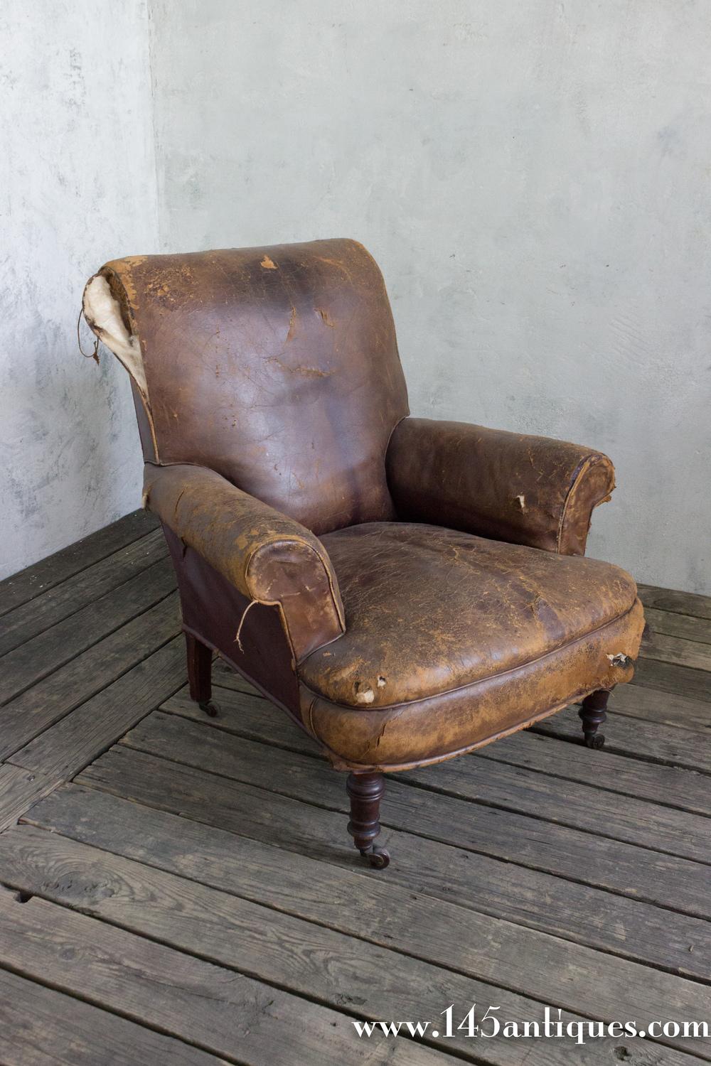 A large French Napoleon III armchair in brown leather. Add luxurious style and comfort to your home with this classic French 19th century Napoleon III leather armchair. Boasting a distinctive silhouette and brown distressed leather upholstery, it is
