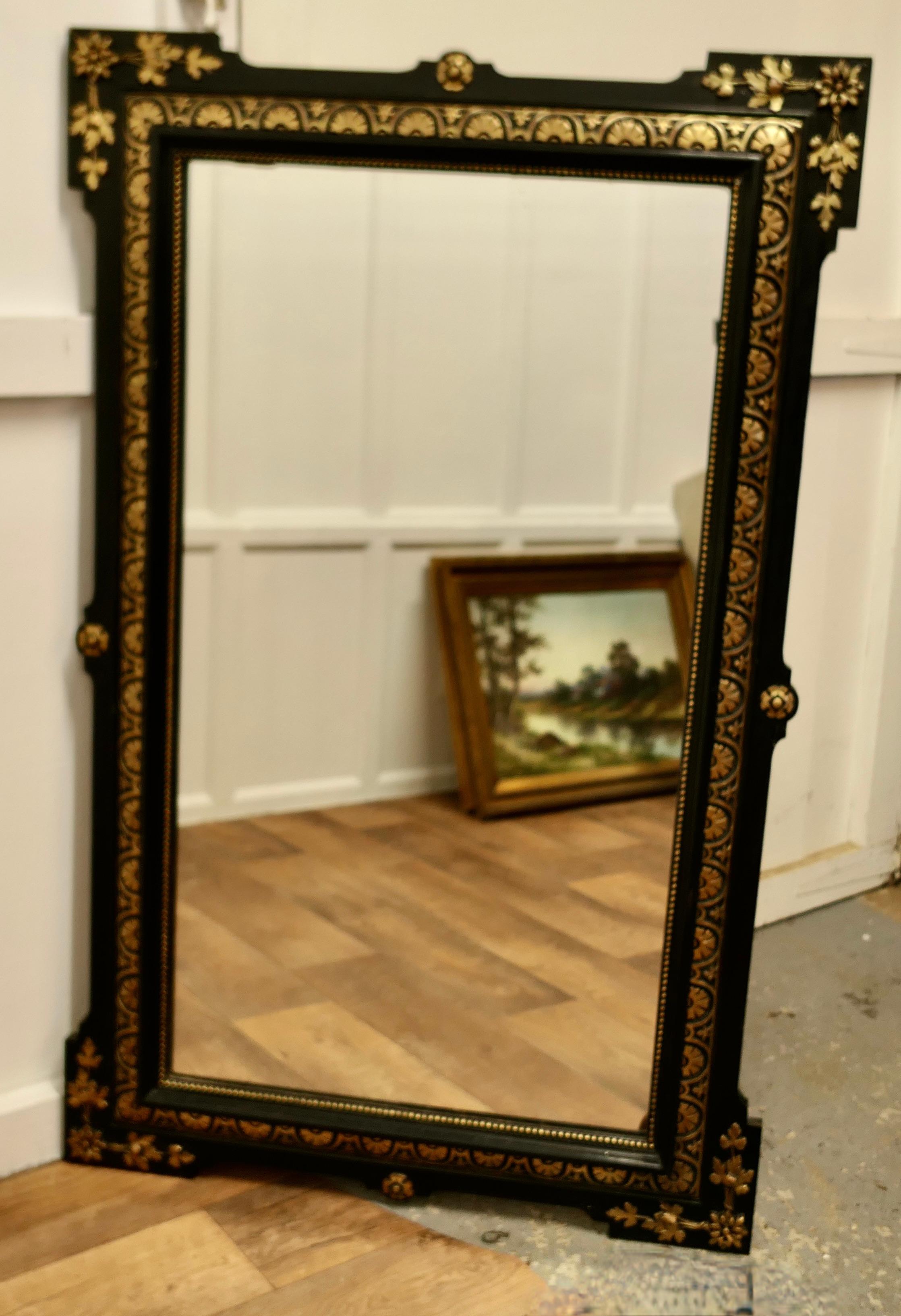 Large French 19th Century Black and Detailed Gold Overmantel Mirror

This is a stunning Overmantel or Wall Mirror a superb example of French chic furnishing, the 4” wide ebonised mirror frame has gold leaf decoration in both a geometric and leaf