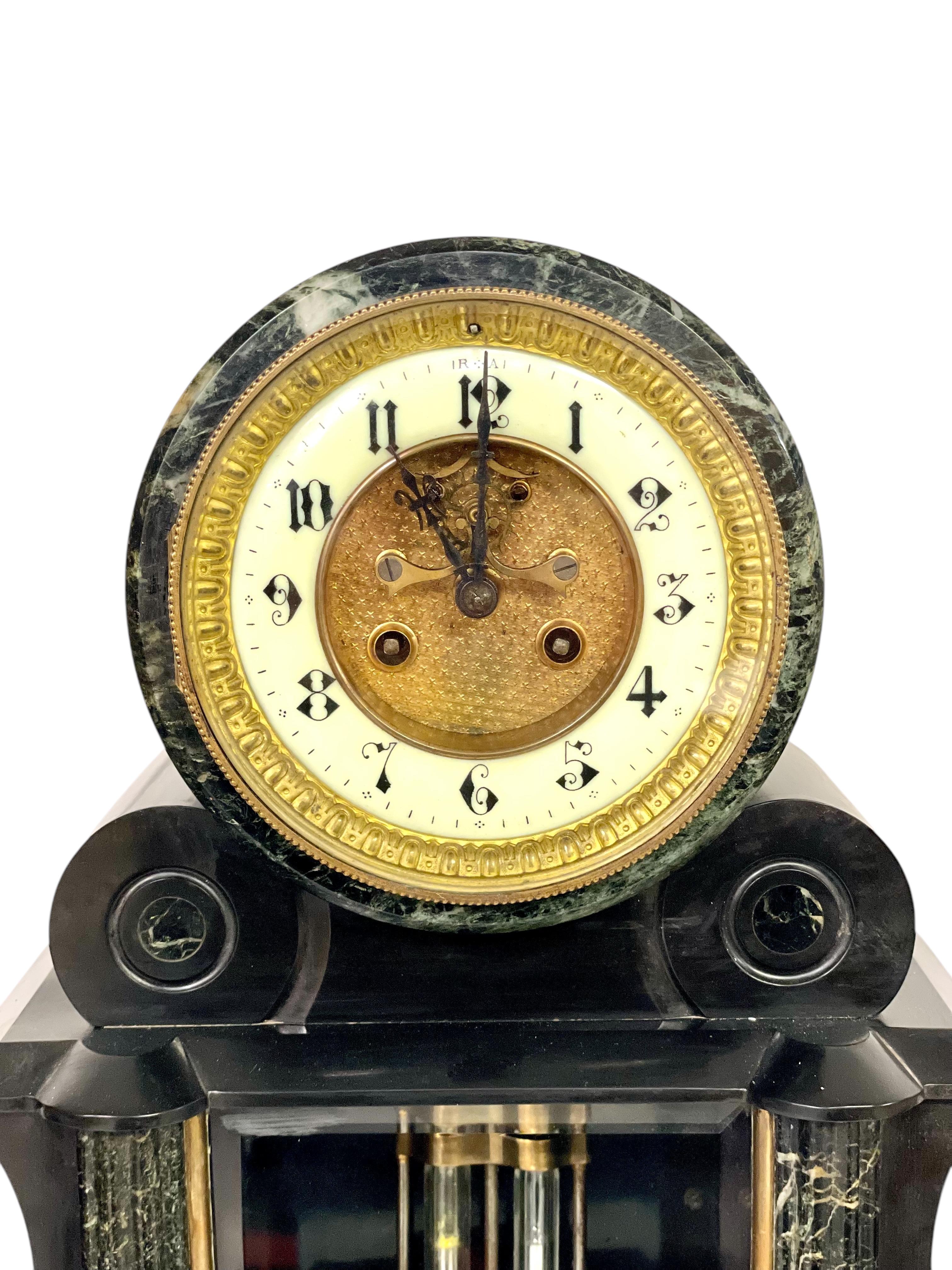 This exceptional Napoleon III period mantel clock set, dating to the late 19th century, exudes elegance and sophistication. The set includes a pendulum clock and two matching cassolettes, meticulously crafted from black marble with striking green
