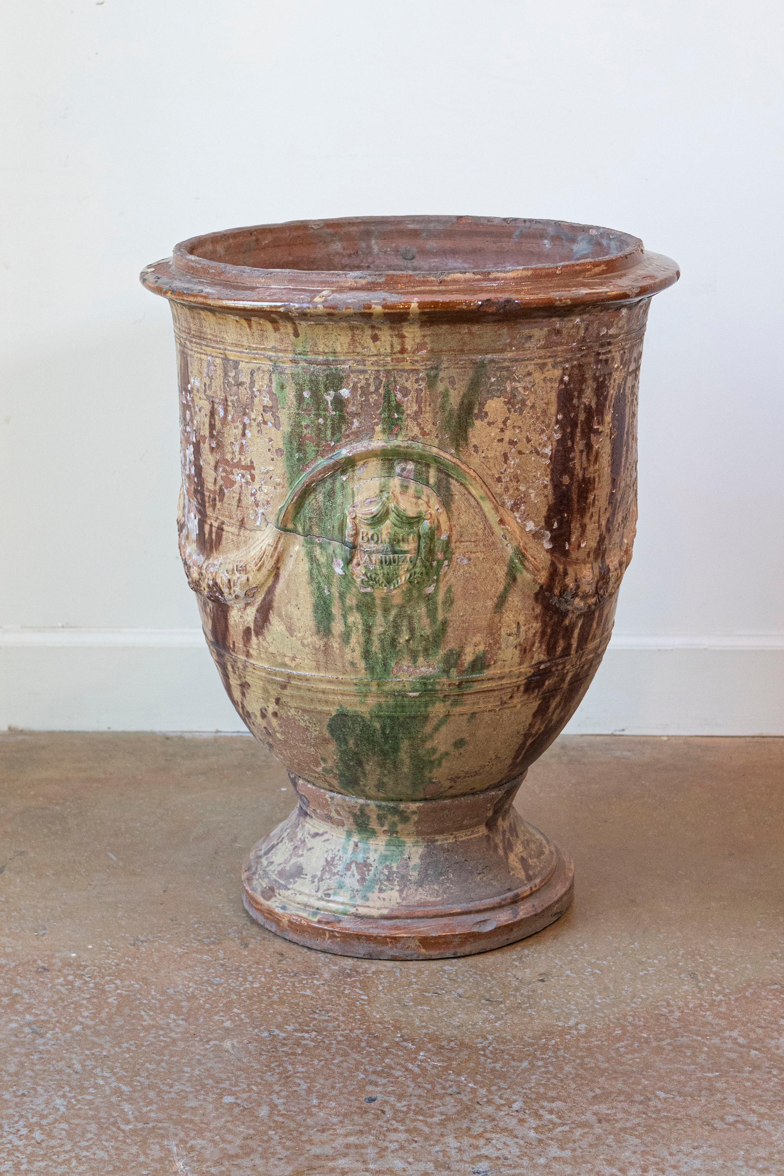 Un grande vaso francese Anduze Boisset del XIX secolo con smalto a goccia marrone scuro e verde e decorazioni a forma di rondine in rilievo. Impregnato di un'aura di eleganza rustica e di artigianato tradizionale, questo grande vaso francese Anduze
