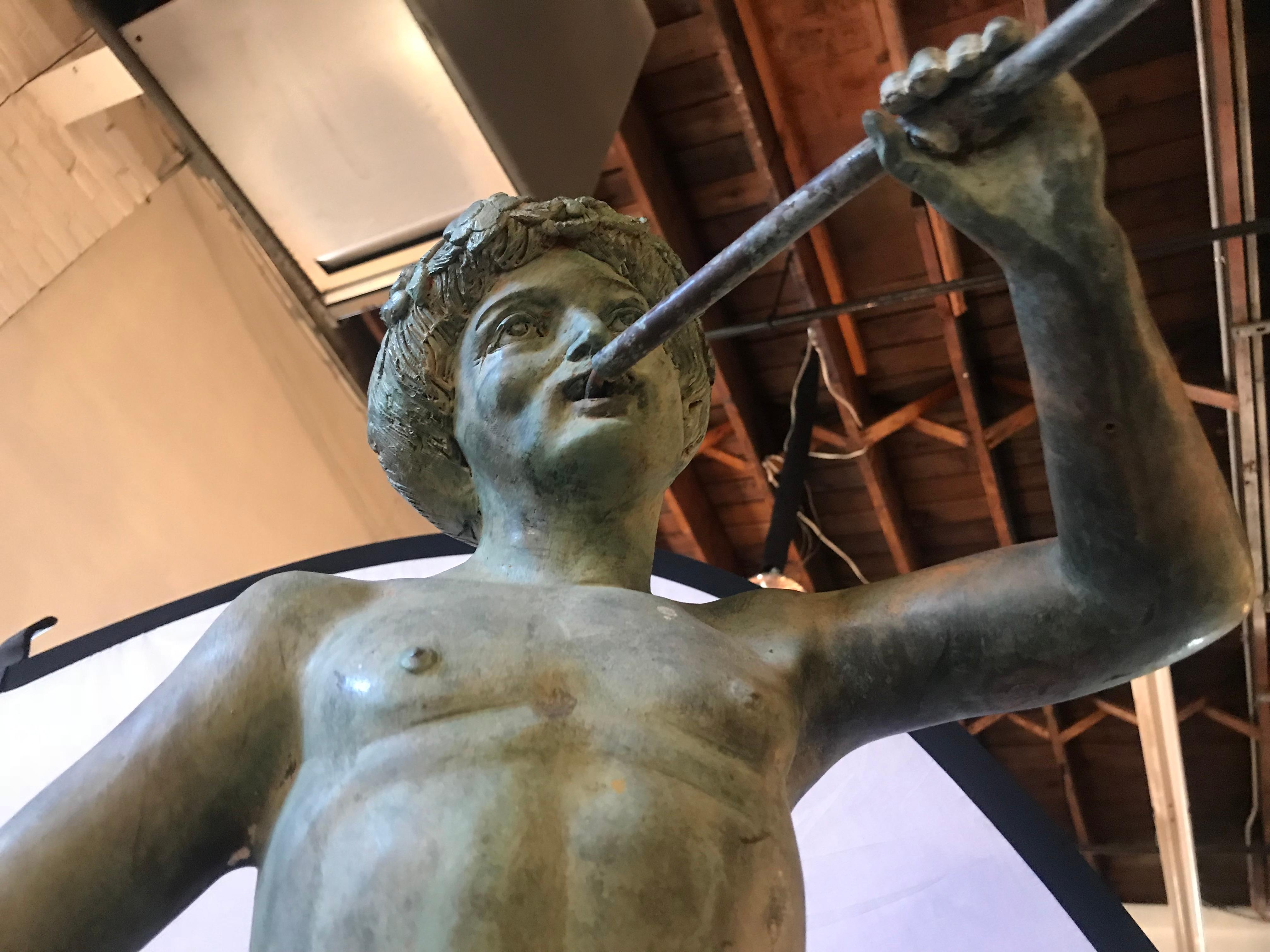 Large French 19th century bronze figure of a naked pan. This weathered and highly decorative bronze of a fluted Pan is naked other than his loin cloth. Finely chased and cast this is a wonderfully decorative bronze worthy of sitting in any yard or