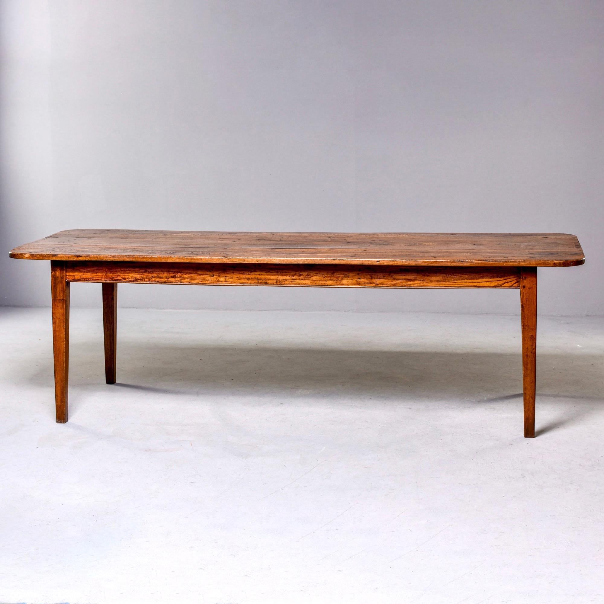 Long elm table with authentic wear and patina to wood, circa 1880s. Super sturdy with single narrow center drawer and rounded corners. Unknown maker.

Measures: End apron height 25”
Side apron height 24.75”.