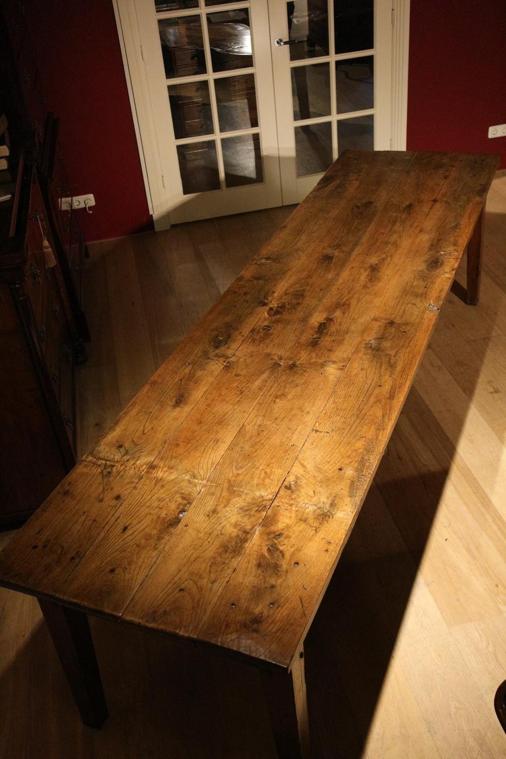 Impressive French oak table in the length of 295cm! The table is beautifully aged and very solid. Table has 2 drawers. An original 19th century French table in this size is unique. The legroom has been increased to 63cm without raising the table.