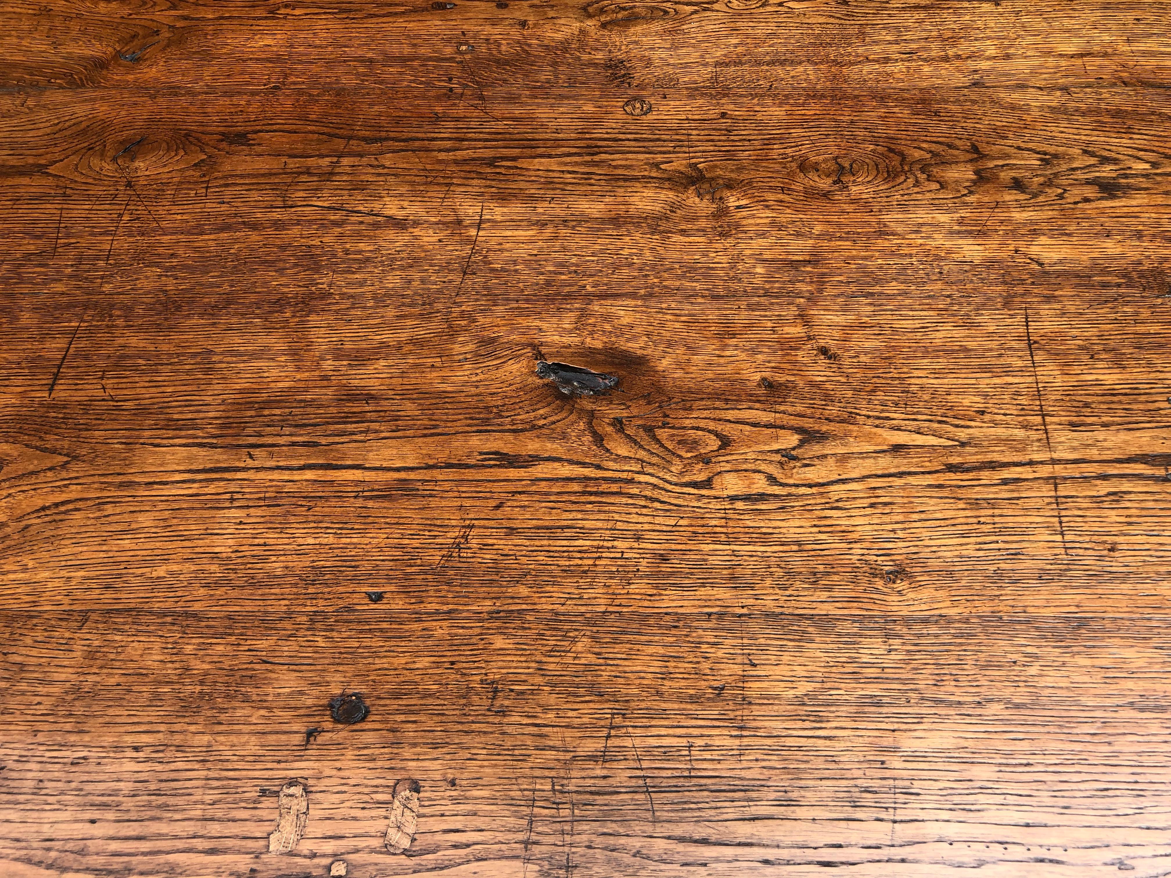 Large thick top French 19th century oak farmhouse table with bread knife drawer with great color, character and patina. This table has been beautifully restored so is completely structurally sound, and it has also been sympathetically repolished by