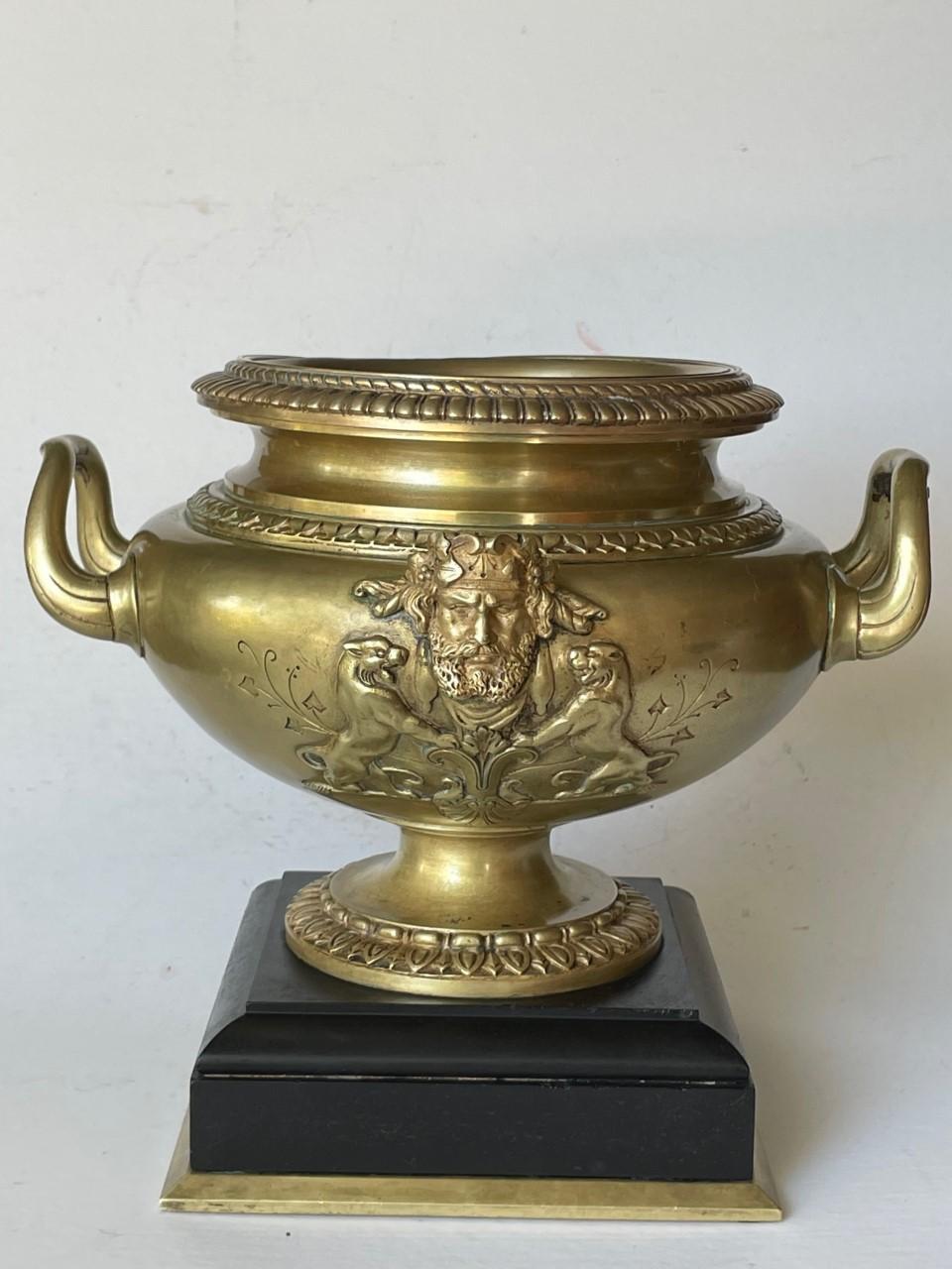 French Large 19th Century Patinated Bronze centerpiece Urn on Marble Base.

Stunning French 19th century Napoleon III period bronze urn raised on a black marble base. The centerpiece urn has a molded rim on the top. Front and back are decorated with