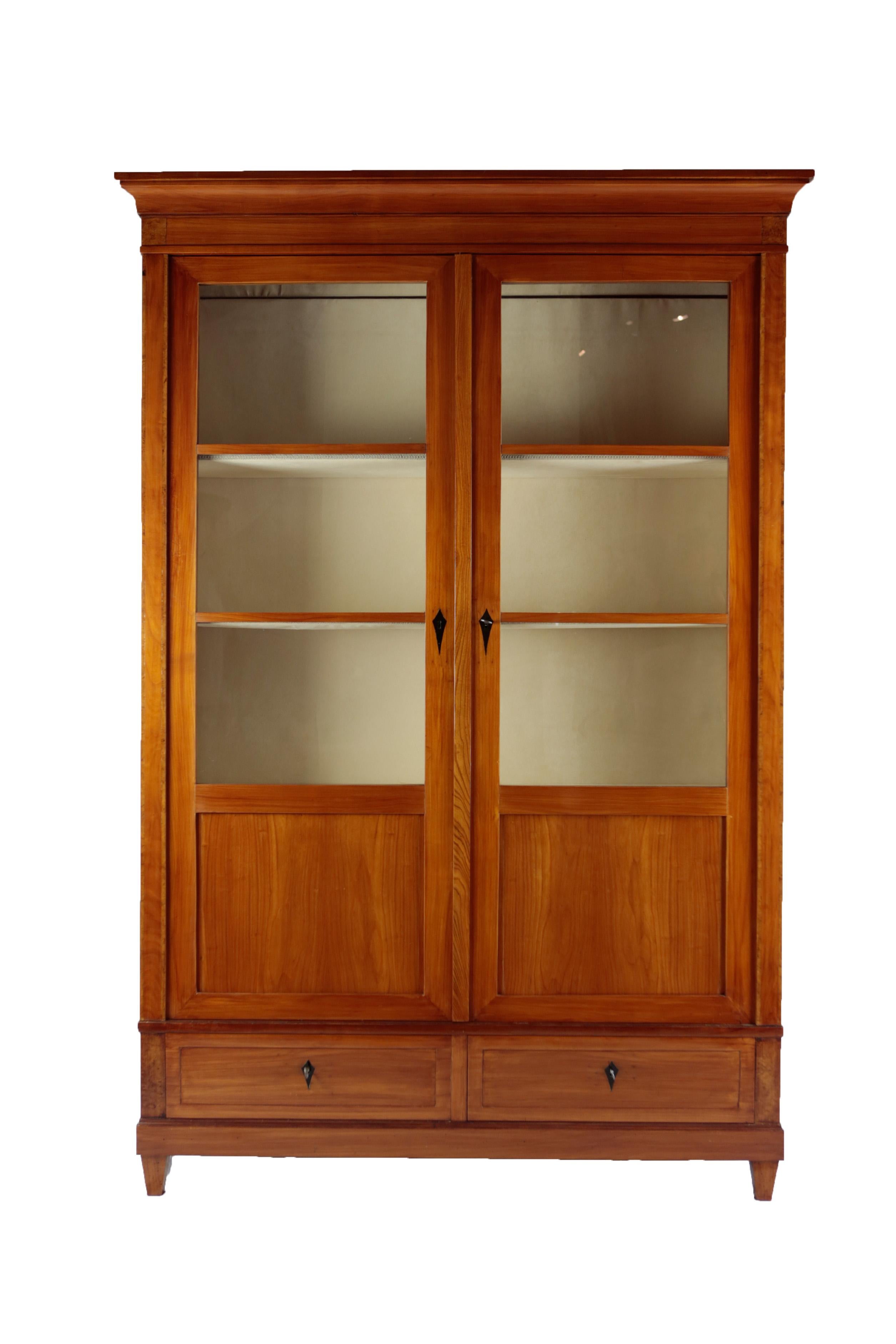 Beautiful 19th century glass cabinet with two doors and inner shelving. The 3 shelves are coated with a soft but durable fabric. 
This french piece of craftmanship with two drawers was build around 1850/60 of Cherrywood. The vitrine is in restored