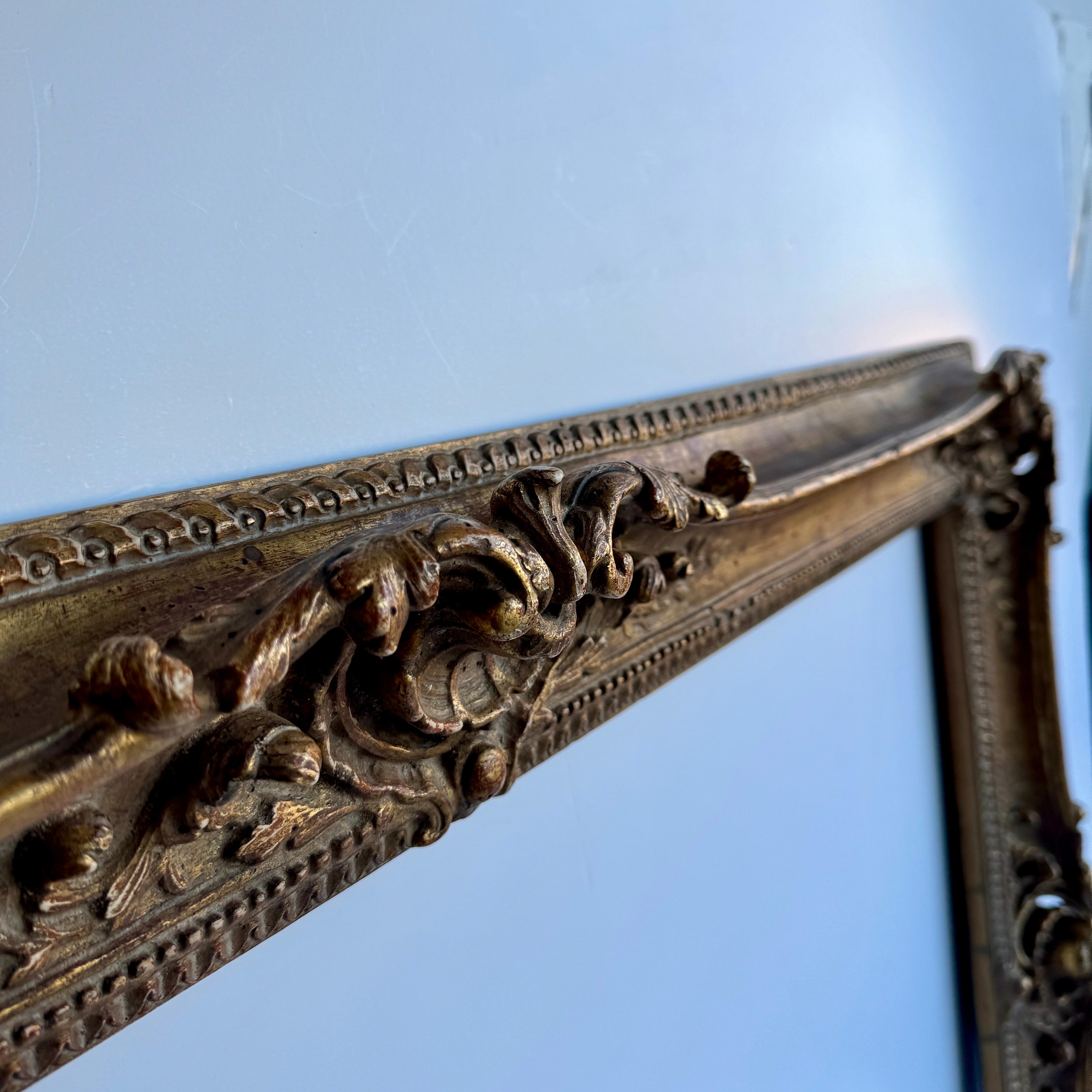 Large Ornate French Rococo Style Carved Ornate Gilt Wood Frame.  

This gorgeous hand-crafted ornate frame has lots of charming details throughout. This substantial piece could be used for an oil painting as well as add a mirror for an incredible