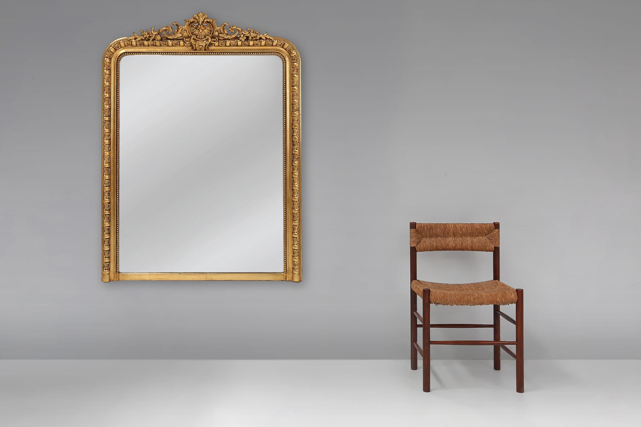 France / 1890 / chimney mirror / wood and plaster / antique

A beautiful large decorated chimney mirror in gilt wood and plaster, made in France around 1890. The mirror has the rounded top corners and a rich, ornamented crest with floral motifs. A