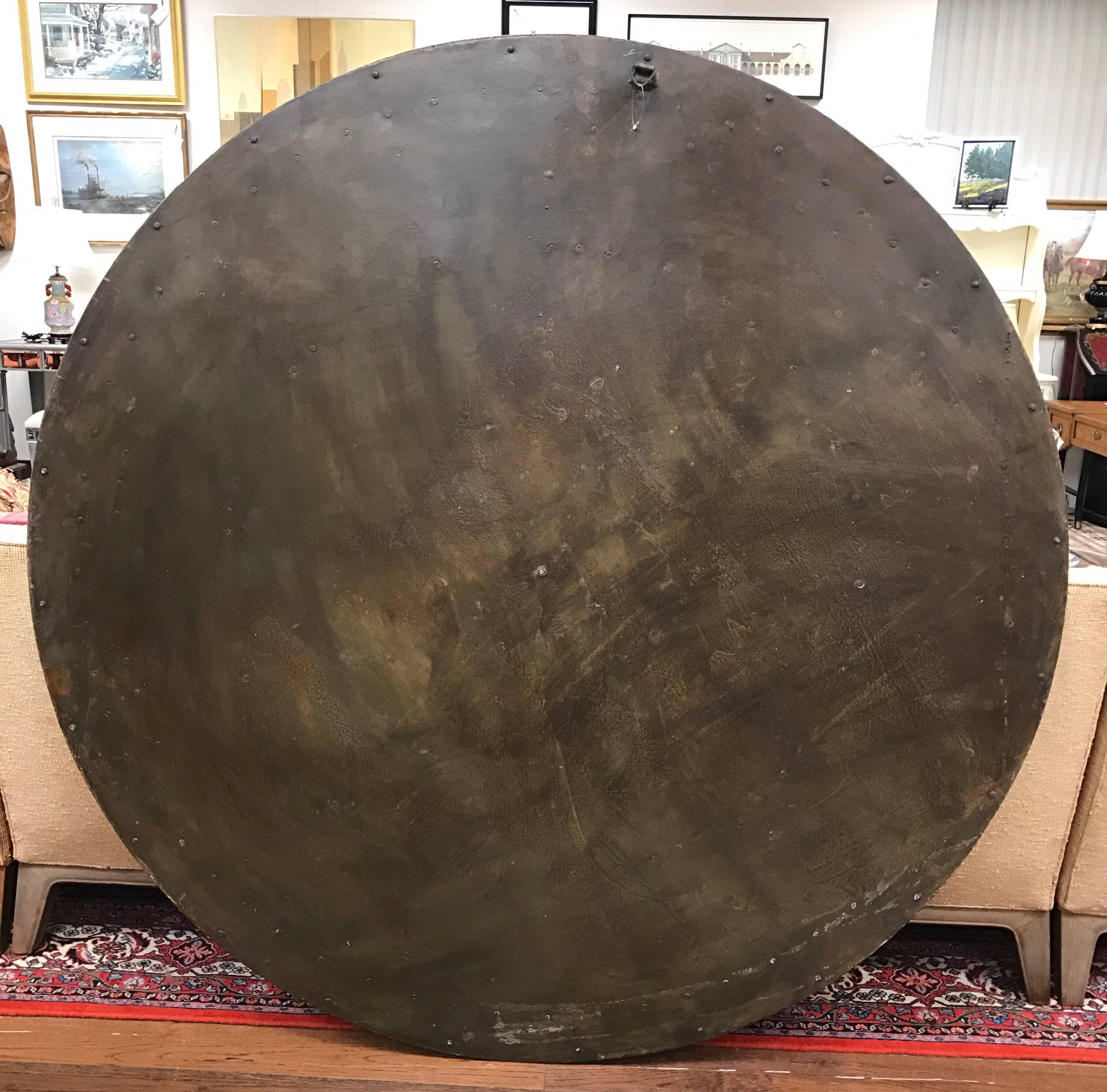 French round turret metal clock face with applied numerals. Features the most perfect patina. One of a kind.
Ready to hang with hook in back. Weight is 60 pounds. Not functional.