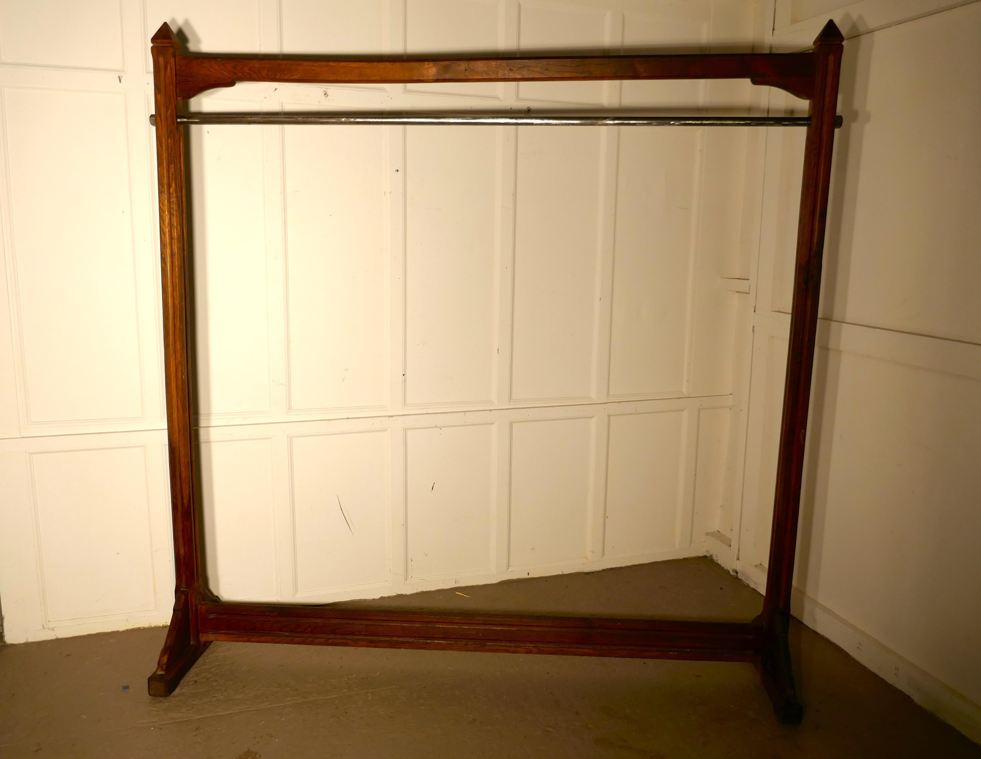 A large French Art & Crafts golden oak clothes rail 

The clothes rail came from a Paris couturier, the frame is made in Golden oak and the rail is made in steel 
The wood is reeded in the Arts & Crafts style, it is stylishly topped off with