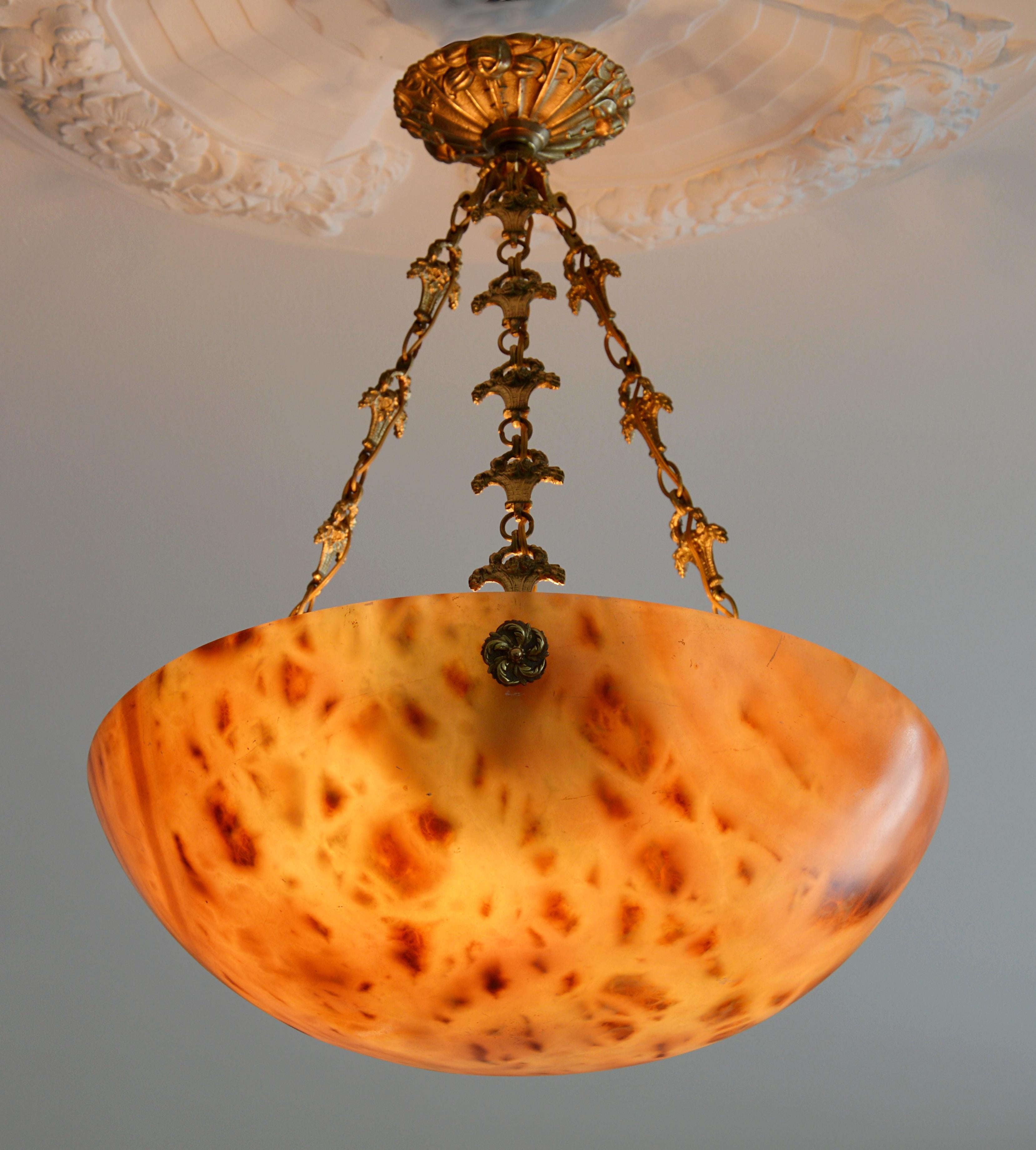 Large French Art Deco chandelier, France, early 1920s. Alabaster and bronze. Large thick alabaster shade hung on its original fixture. Old alabaster cannot be compared to new ones. Old alabaster has veins. Sometimes they can be mistaken for cracks.