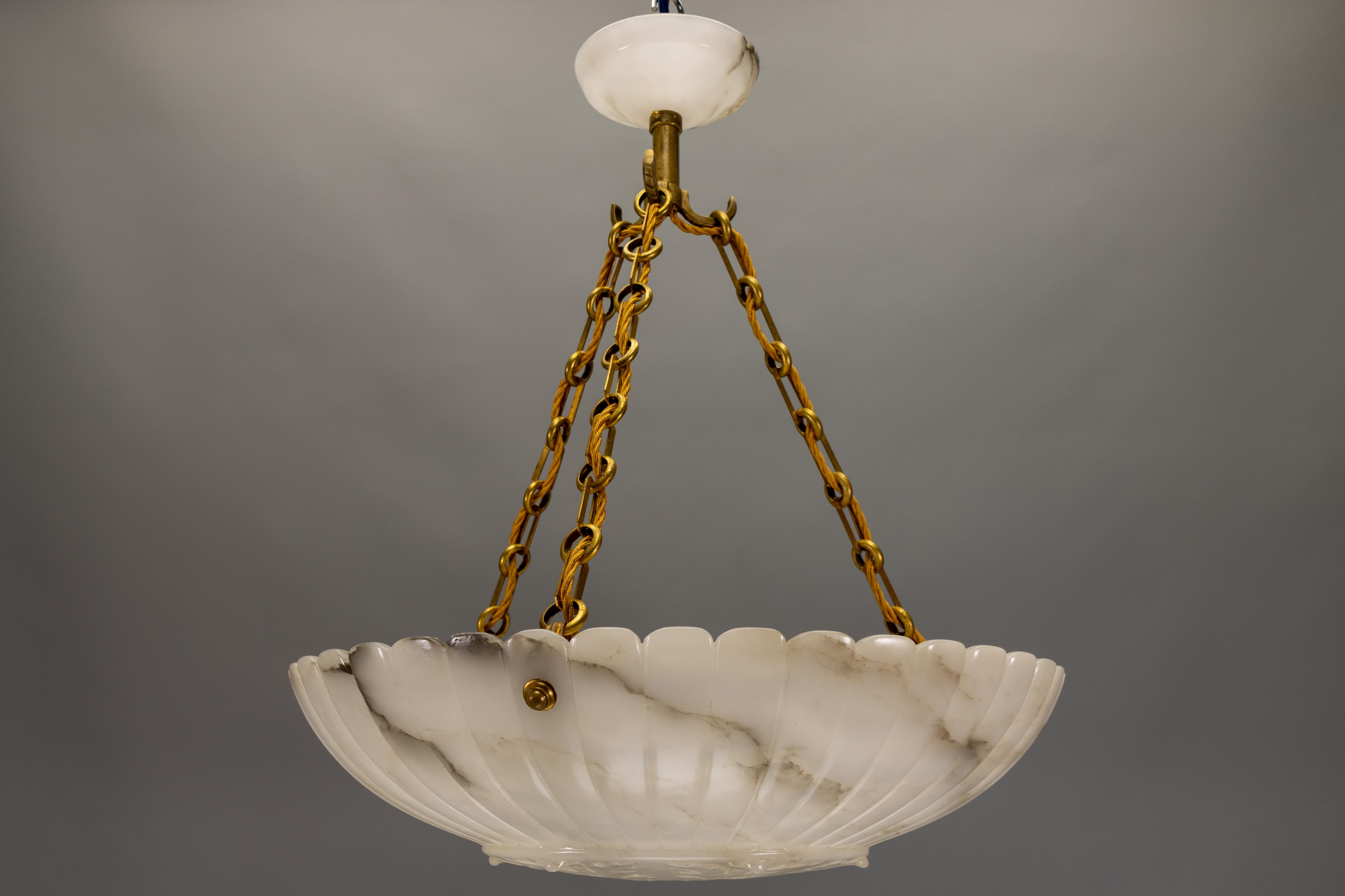 An impressive French Art Deco alabaster pendant light from the 1920s – sculptural in form, richly veined, and glowing with a dimensional, cloud-like effect when illuminated.

This large French Art Deco pendant light, dating to the 1920s, combines