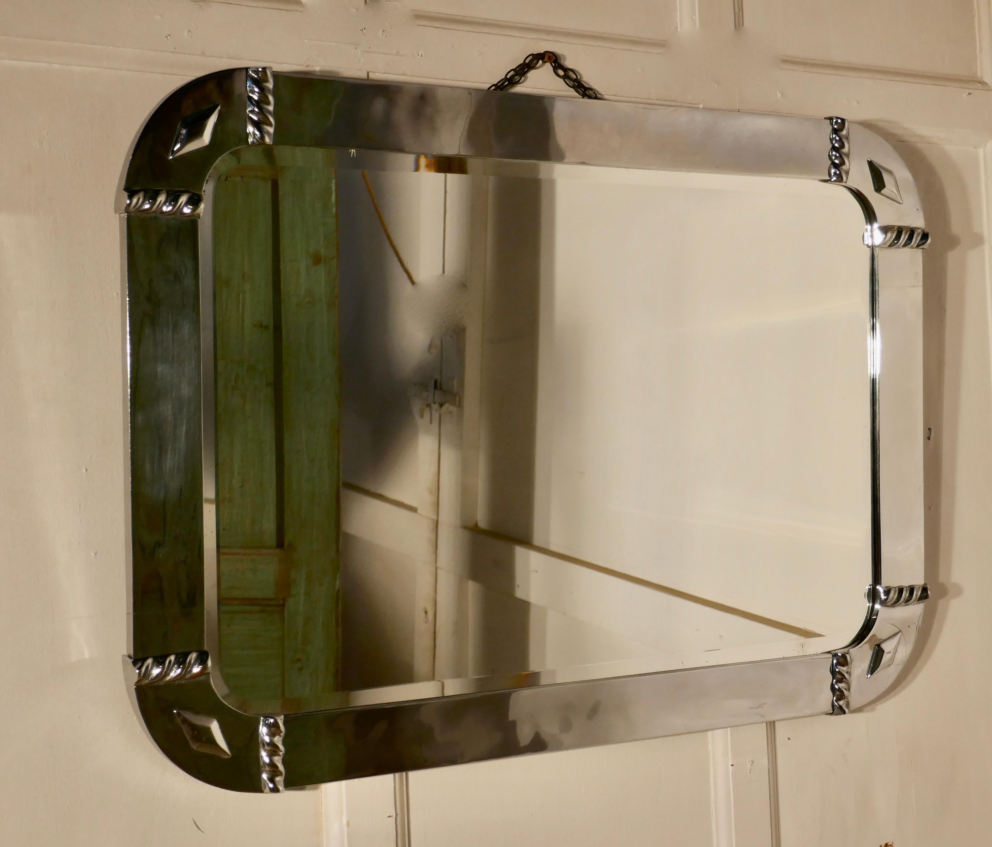 Large French Art Deco chrome wall mirror

This is a very stylish piece, the mirror has a 3” wide chrome frame with large curving corners and a diamond decoration to each 

The mirror is in good condition with little signs of its age
The mirror