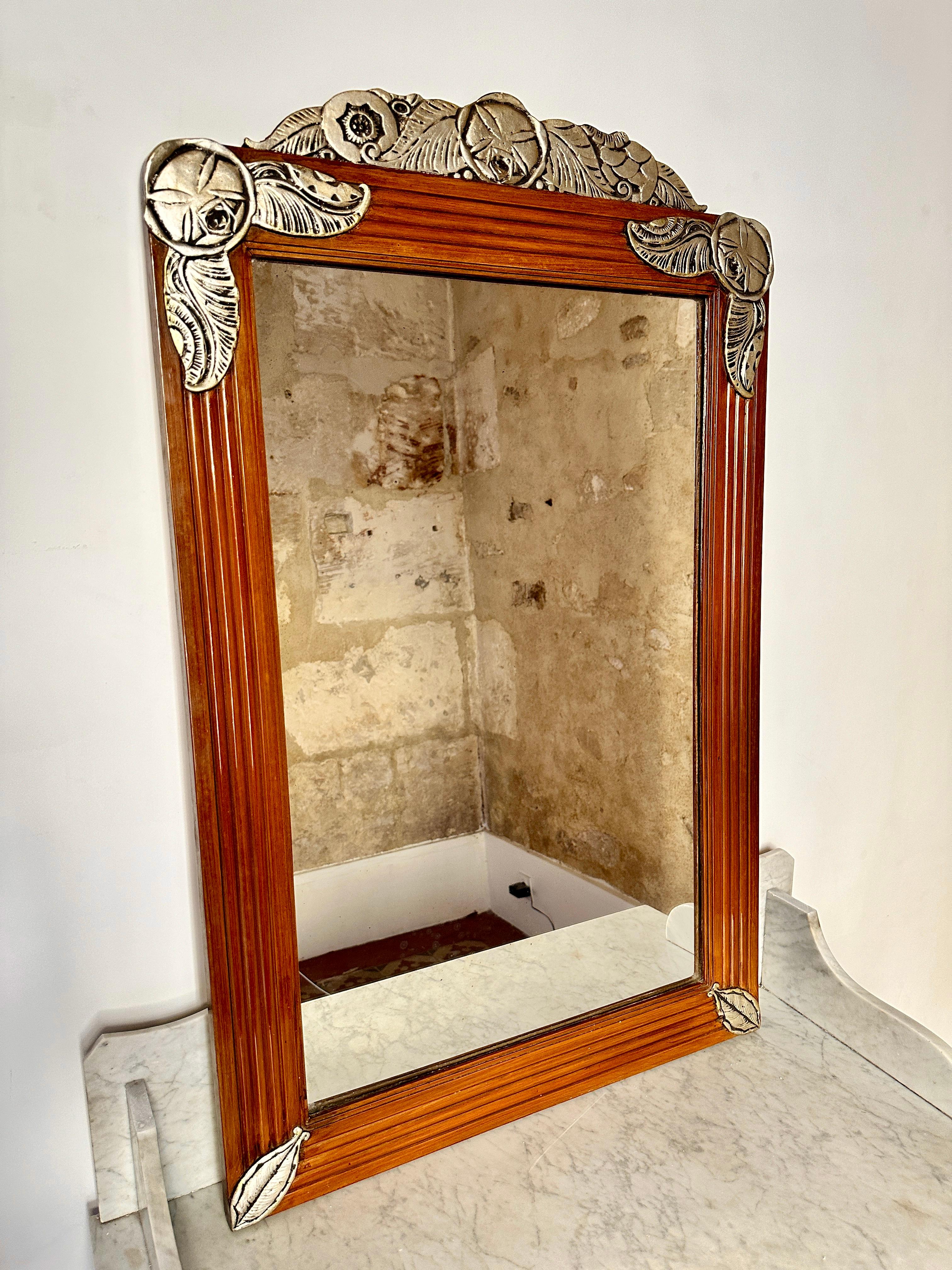 Large French Art Deco fruitwood mirror.

Gorgeous 1930s mirror with reeded frame and gilded silver decorative reliefs. In excellent condition with very light and attractive foxing.

Height 104cm Width 65cm