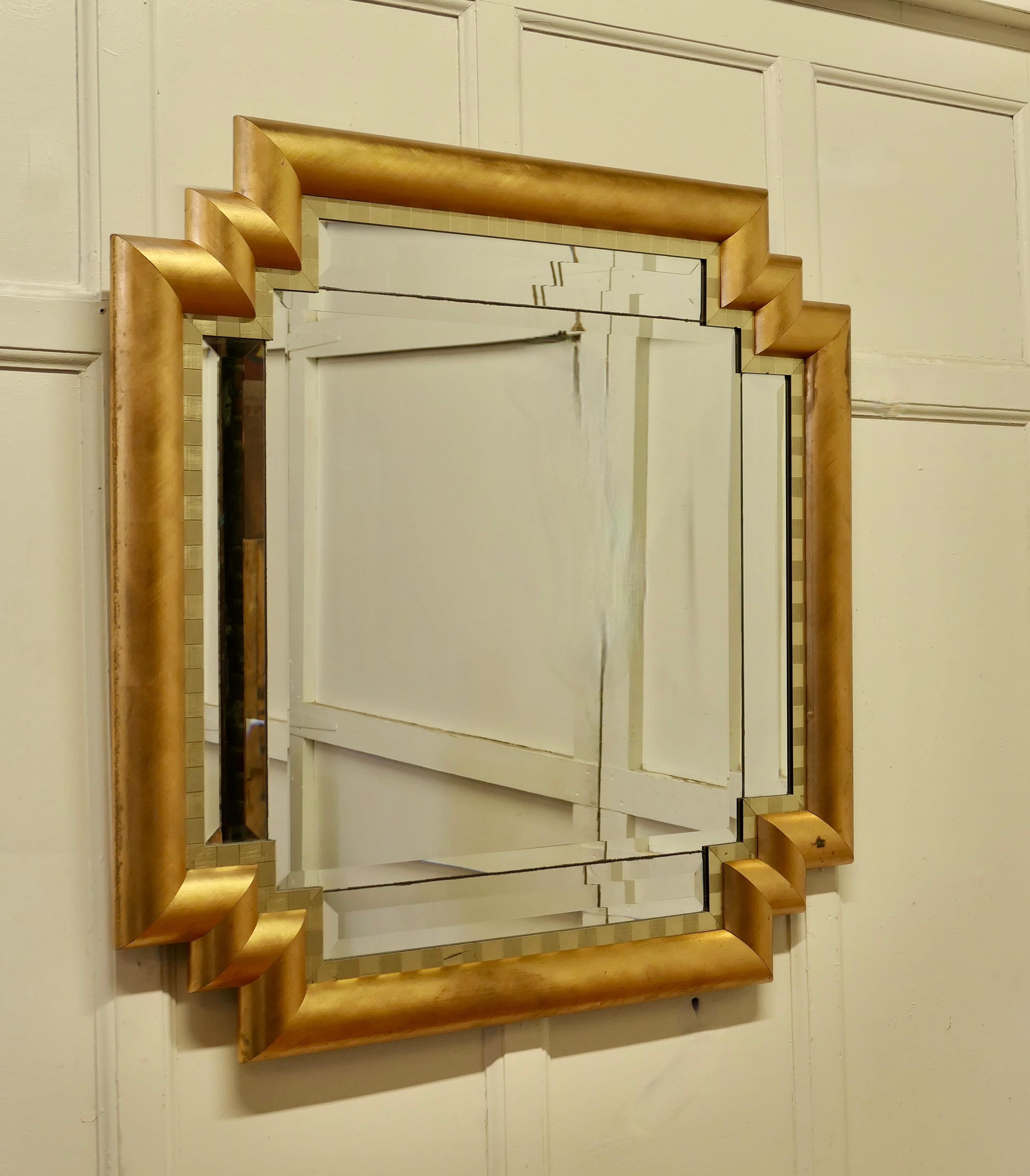 Large French Art Deco Odeon Style Gilt Mirror

The Art Deco frame has an odeon style stepped corner and a 4” wide D shaped Gilt frame 
This is a lovely and a fine quality piece, just like a cushion Mirror the central bevelled glass is set with